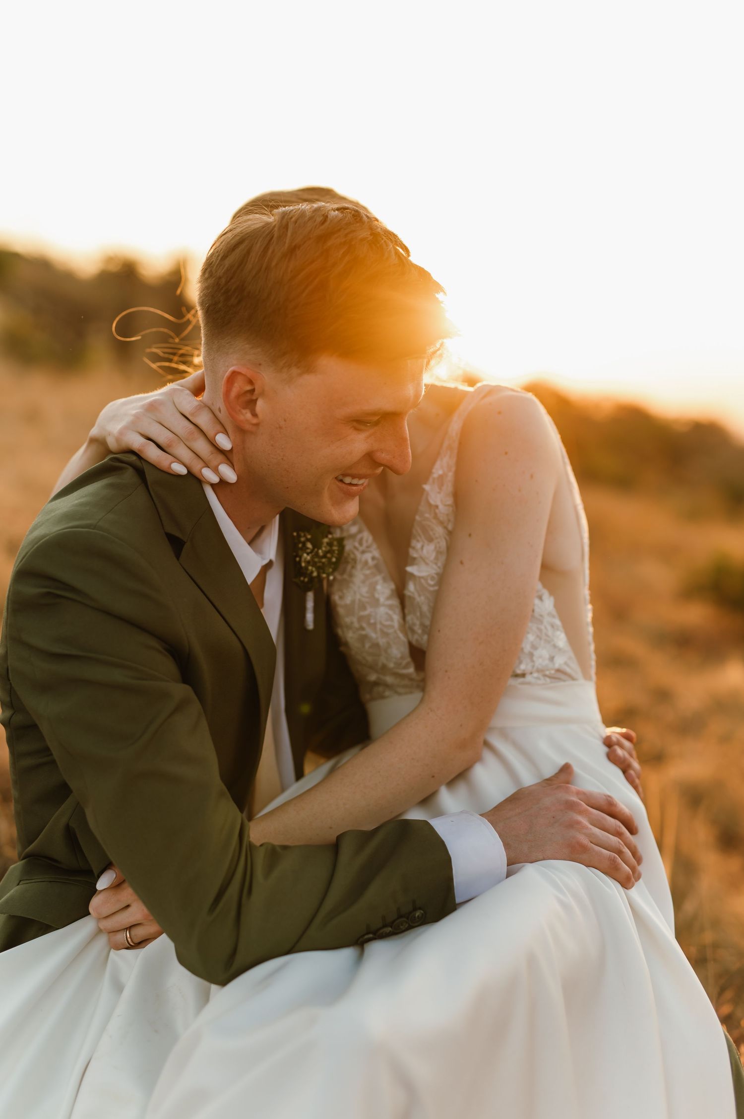 Intimate wedding couple portrait captured in warm sunset light.