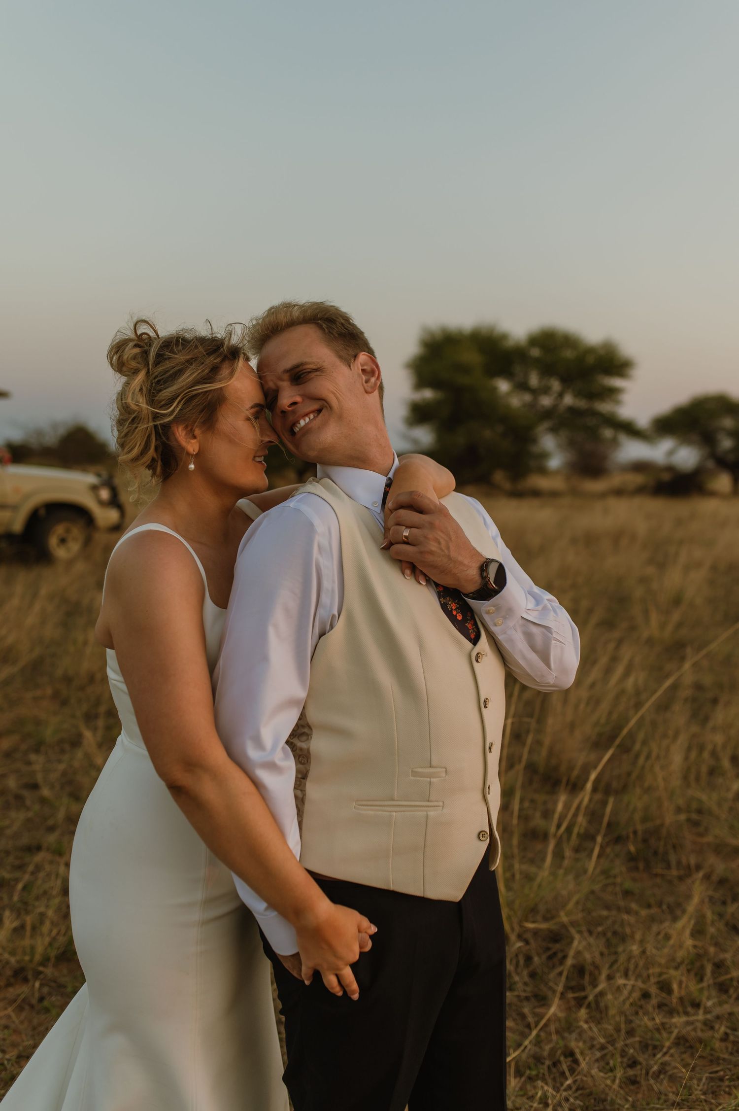 Tender moment between couple during sunset wedding photography session.
