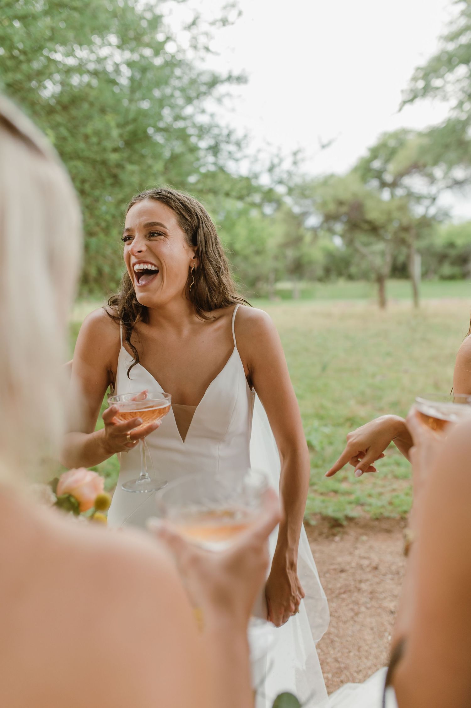 Wedding guests enjoying cocktails and conversation at outdoor reception.
