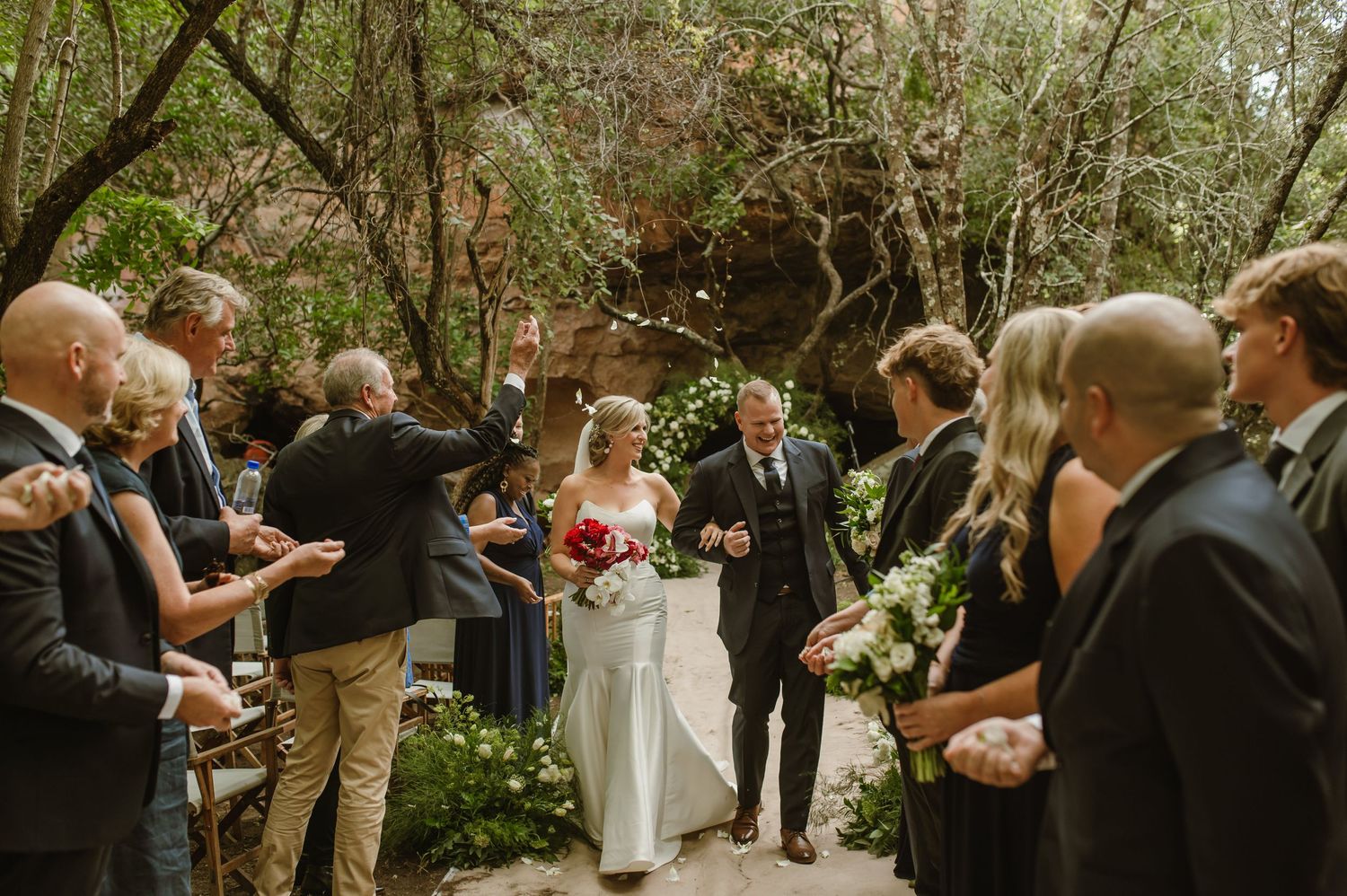 Wedding guests gather for an intimate ceremony in a serene outdoor garden setting.