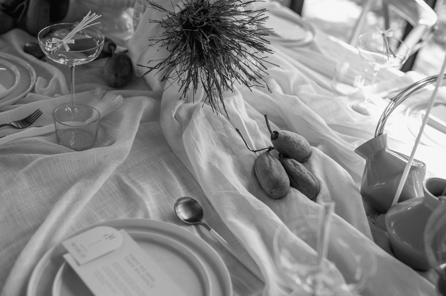 Close-up details of white formal wear and decorative elements in an event setting.