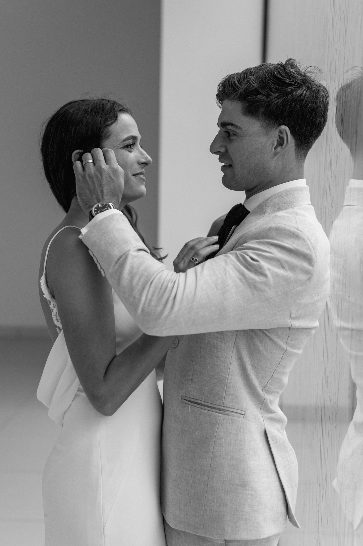 Artistic black and white series capturing tender moments between a couple in formal attire.