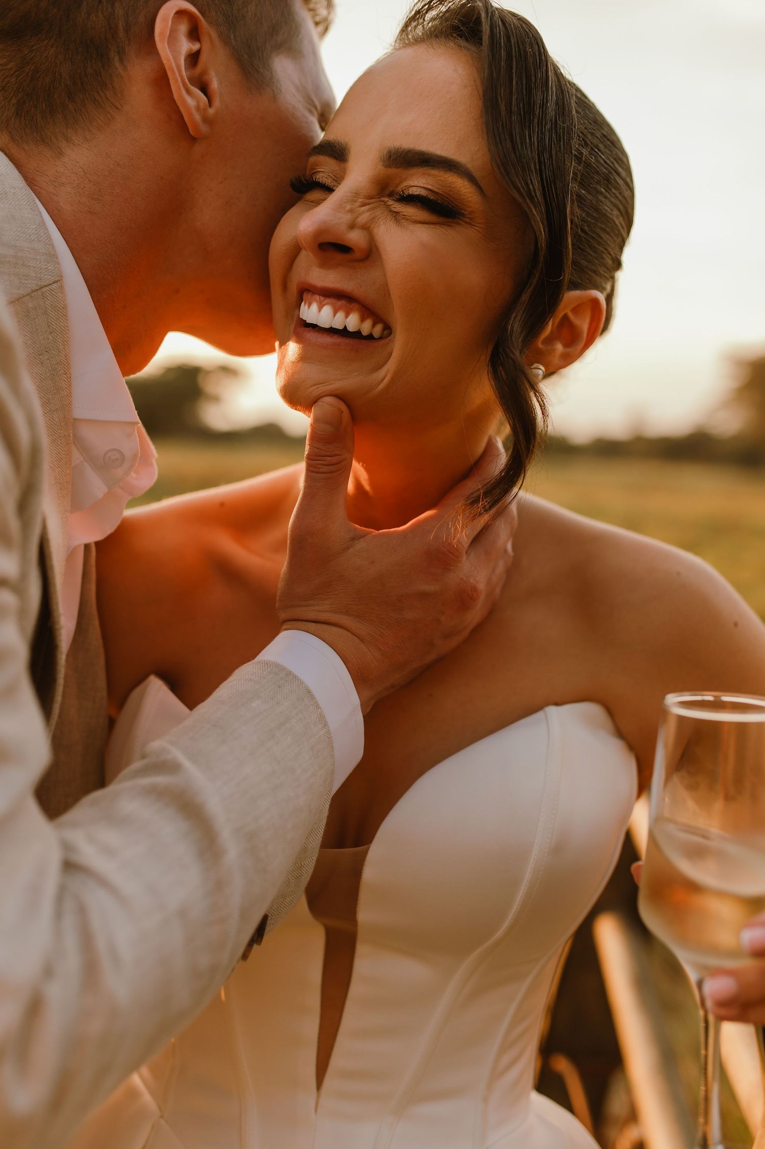 An intimate moment captured between a couple during sunset with warm golden lighting.