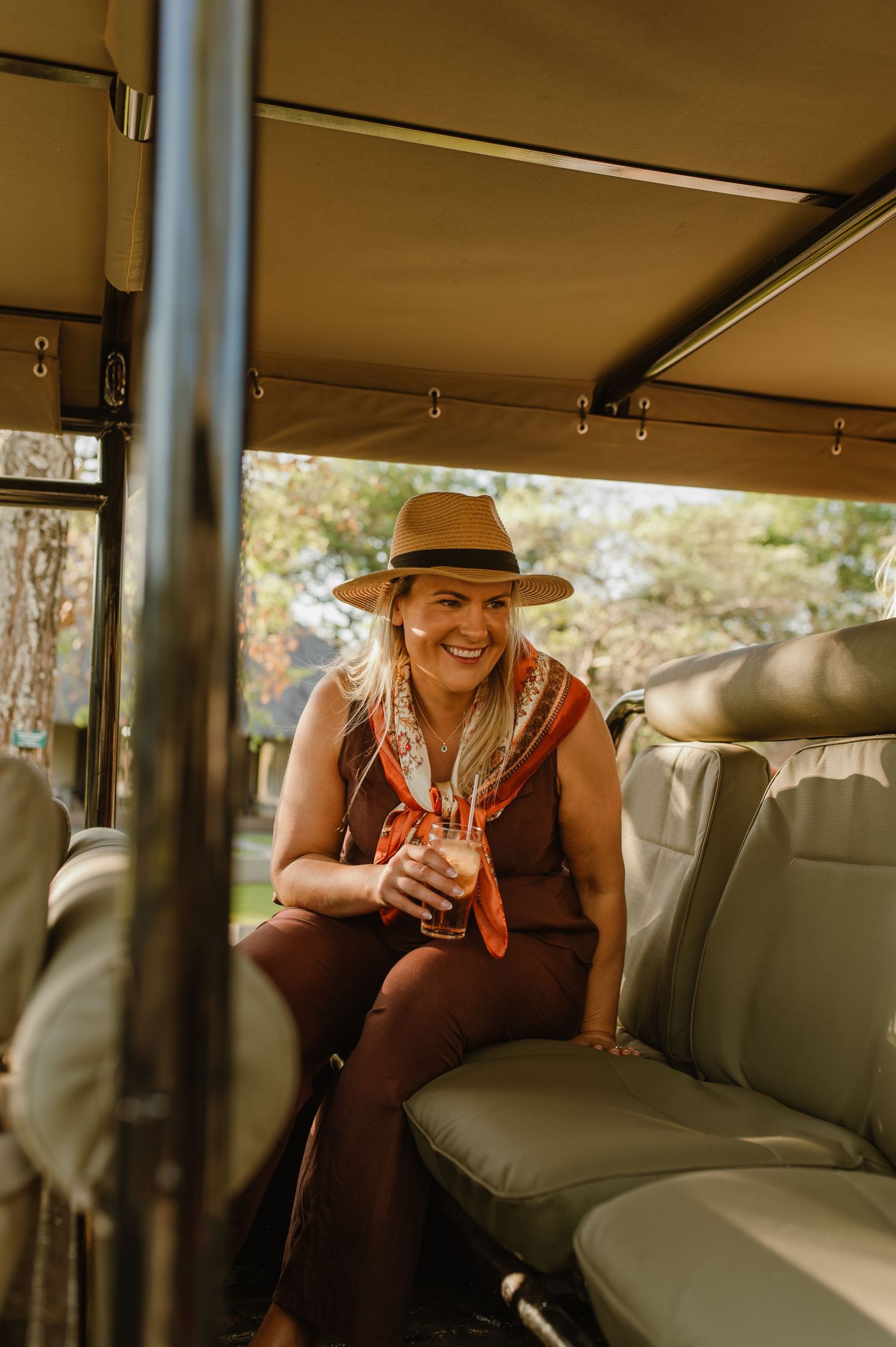 Interior view of safari vehicle with cushioned bench seating.