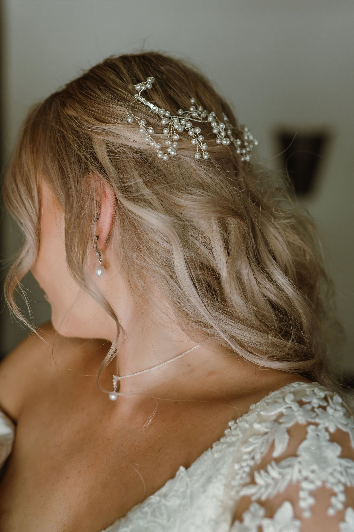 Detailed shots of bridal hair accessories and lace details against blonde updo hairstyle.