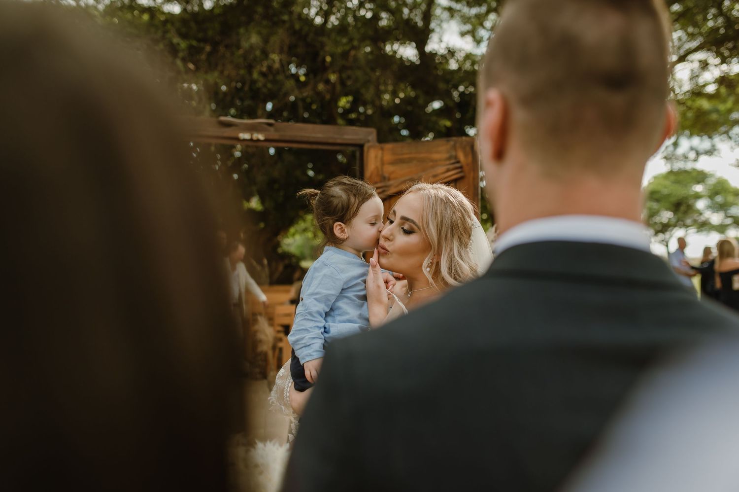 Intimate wedding moment captured during outdoor celebration.