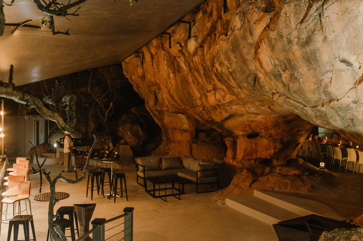 Interior view of a rustic cave venue with natural rock formations and ambient lighting.