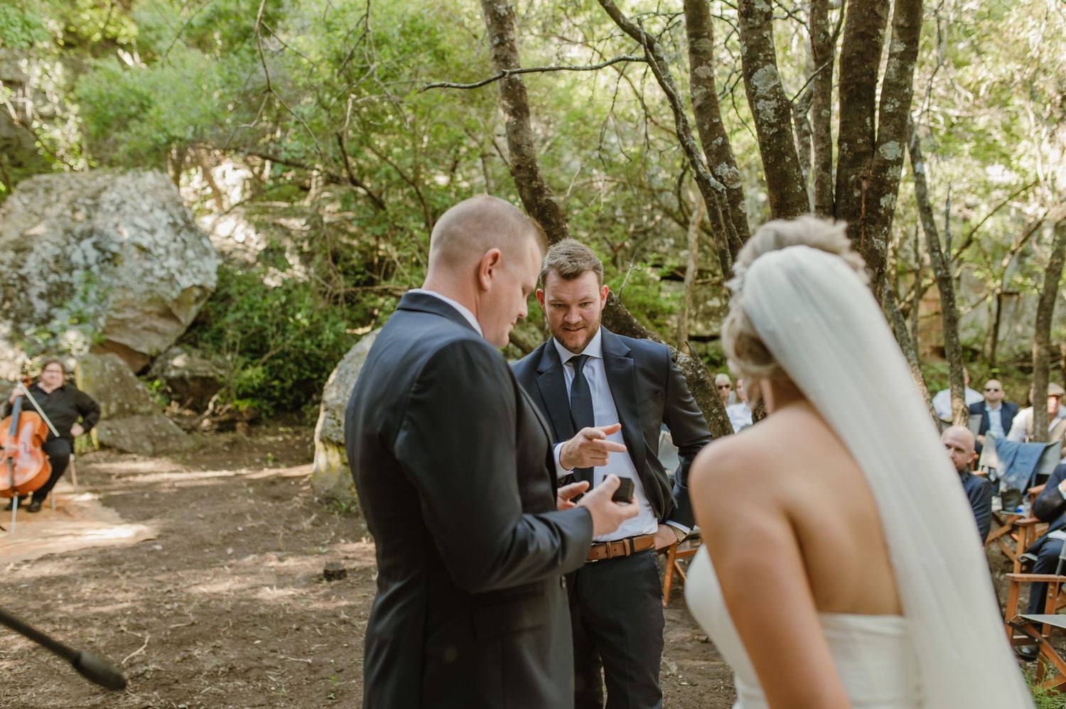 Intimate wedding ceremony moments captured in a sunlit forest setting.