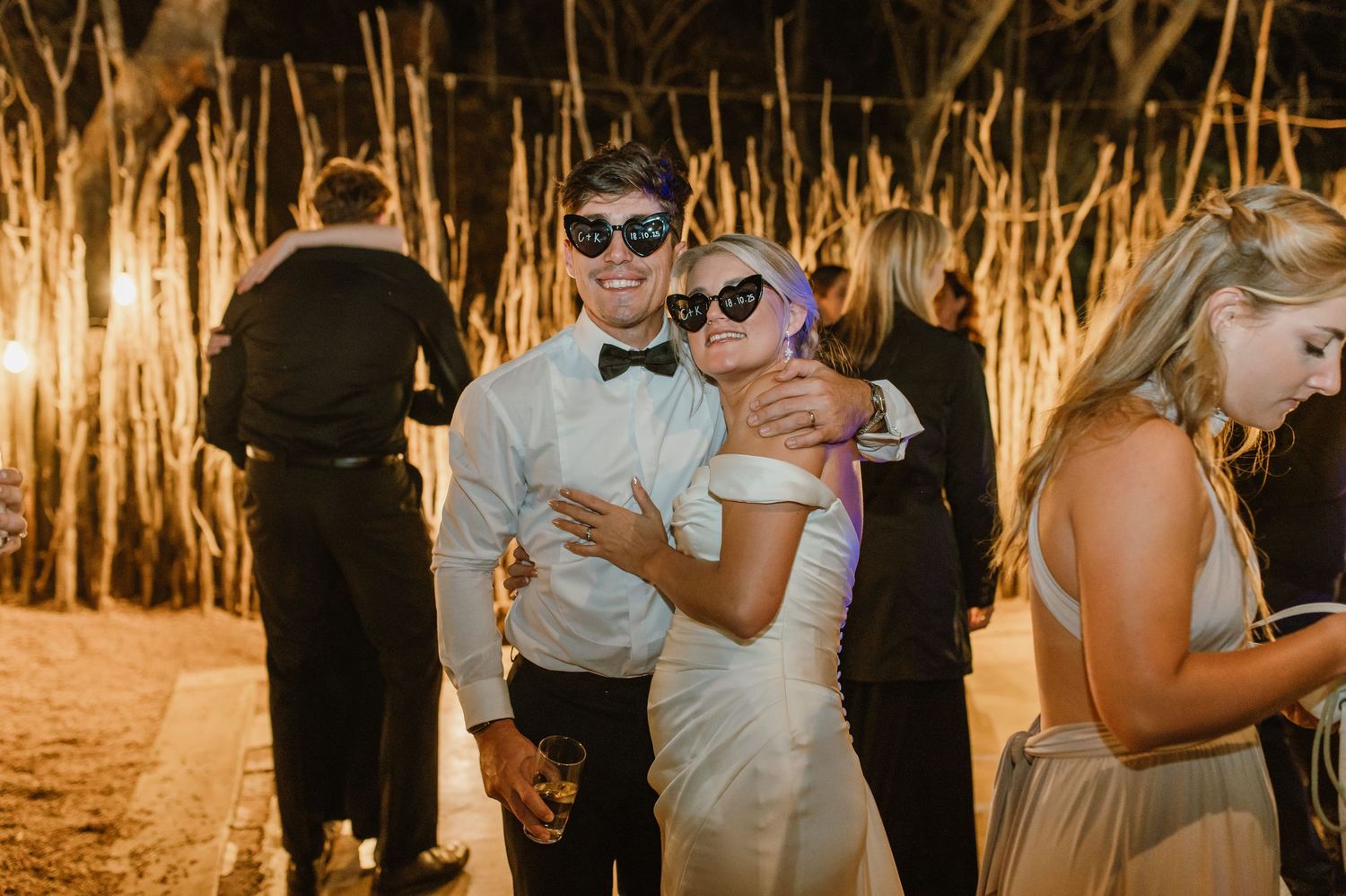 Evening celebration with guests dancing under warm lighting and rustic decor.