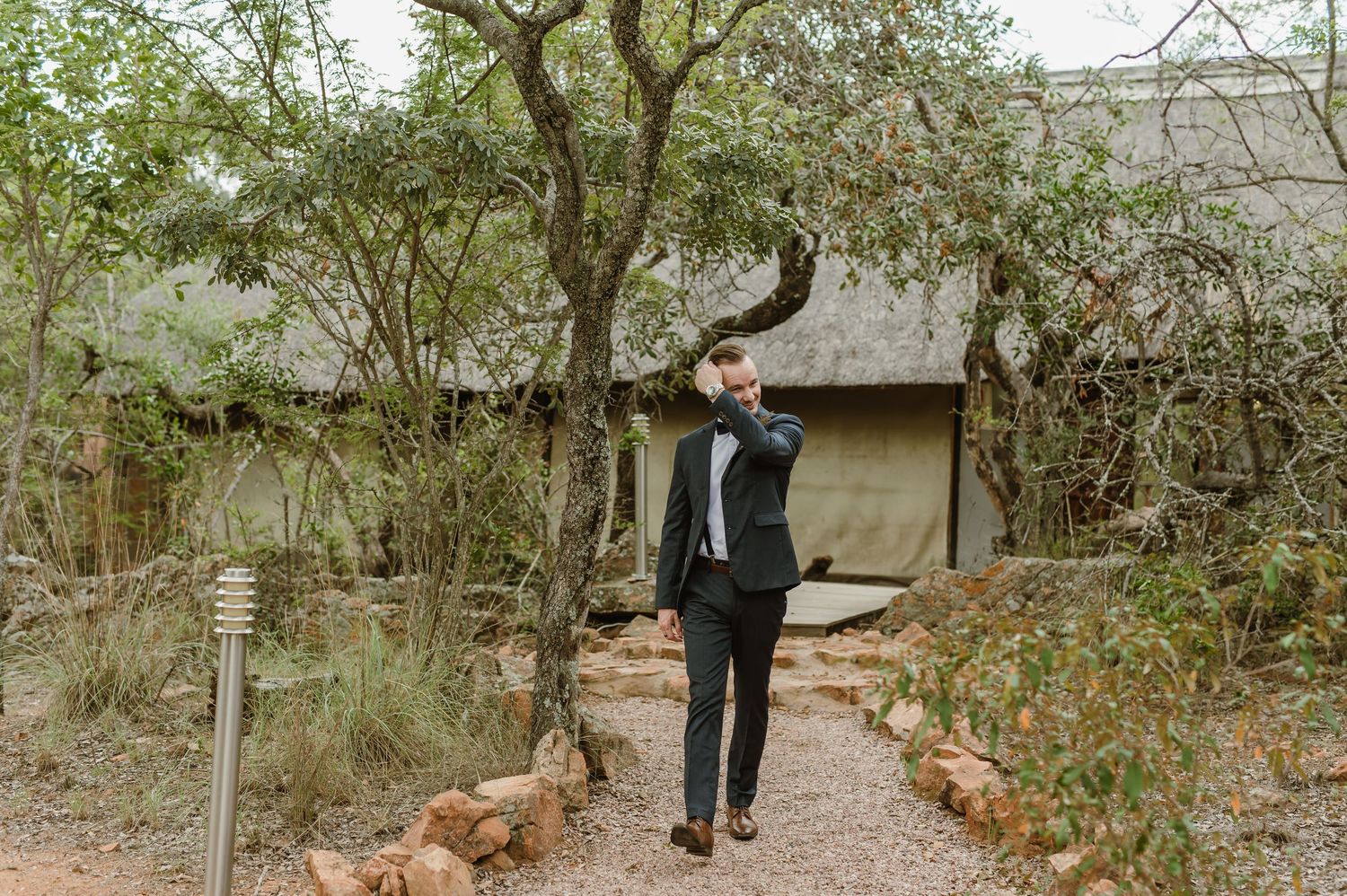 A path through wooded terrain with natural stone borders.