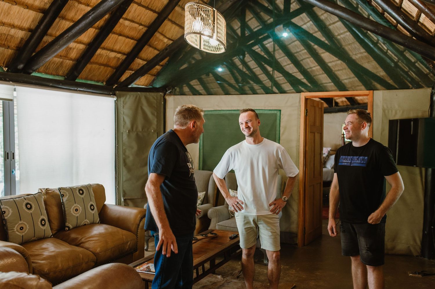 A rustic room with wooden beams and leather furniture showing casual gathering moments.