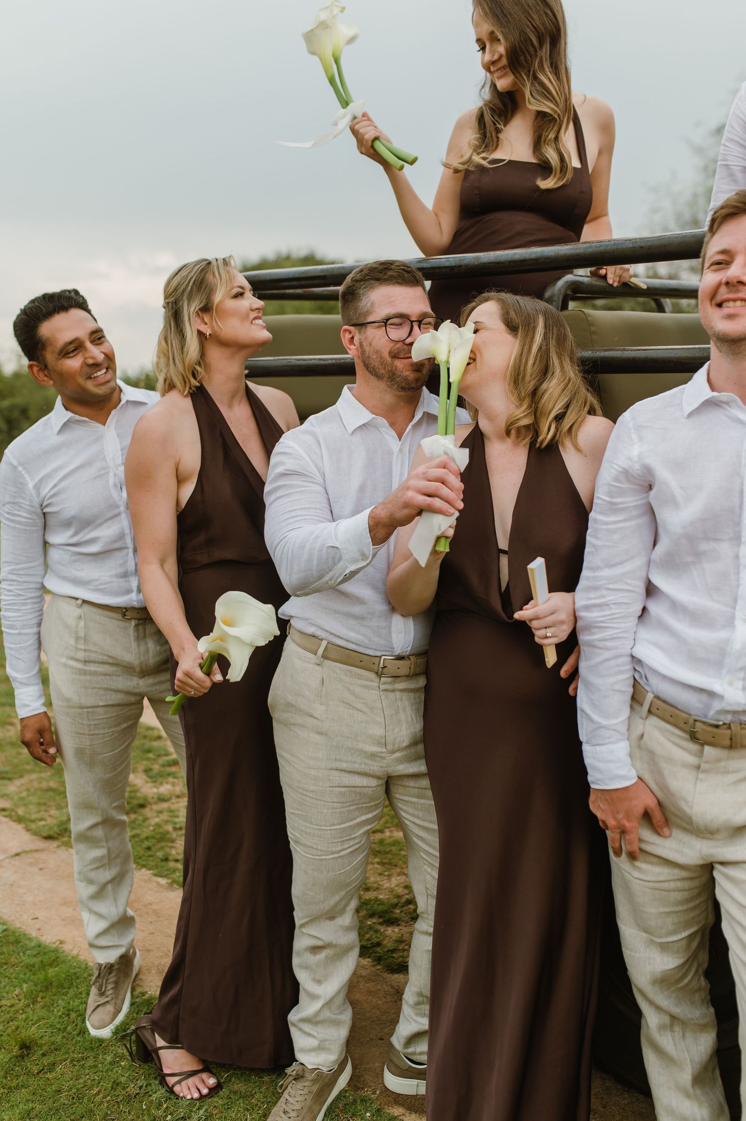 A candid sequence of wedding party members in brown dresses and beige suits laughing together outdoors.