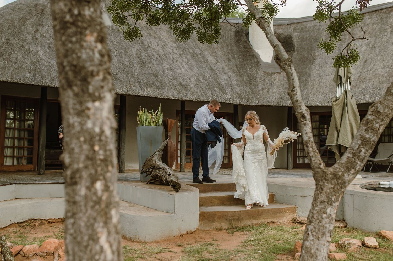 Outdoor wedding venue shots with rustic architecture and natural greenery.