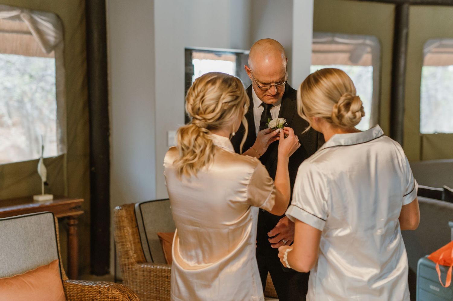 Candid interaction sequence under a thatched roof interior.