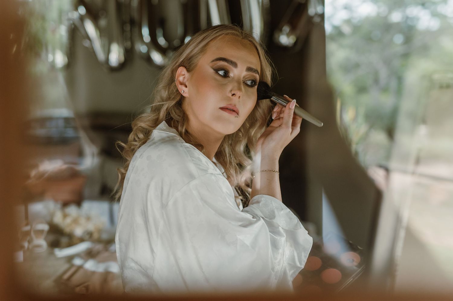 Getting ready scene with soft natural lighting and wedding preparations.