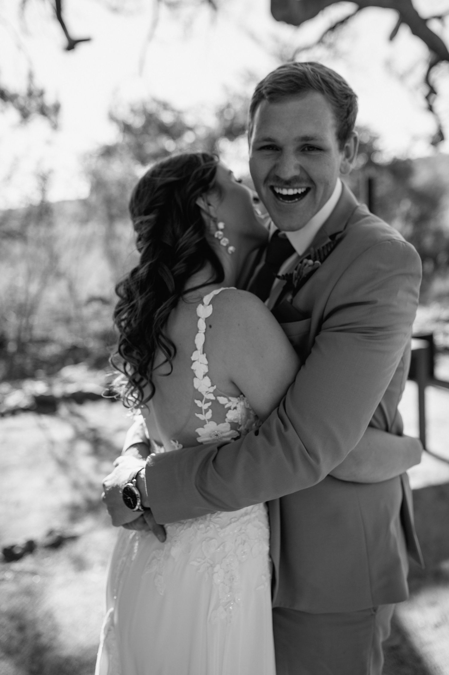 Black and white wedding portraits capture joyful moments under natural lighting.