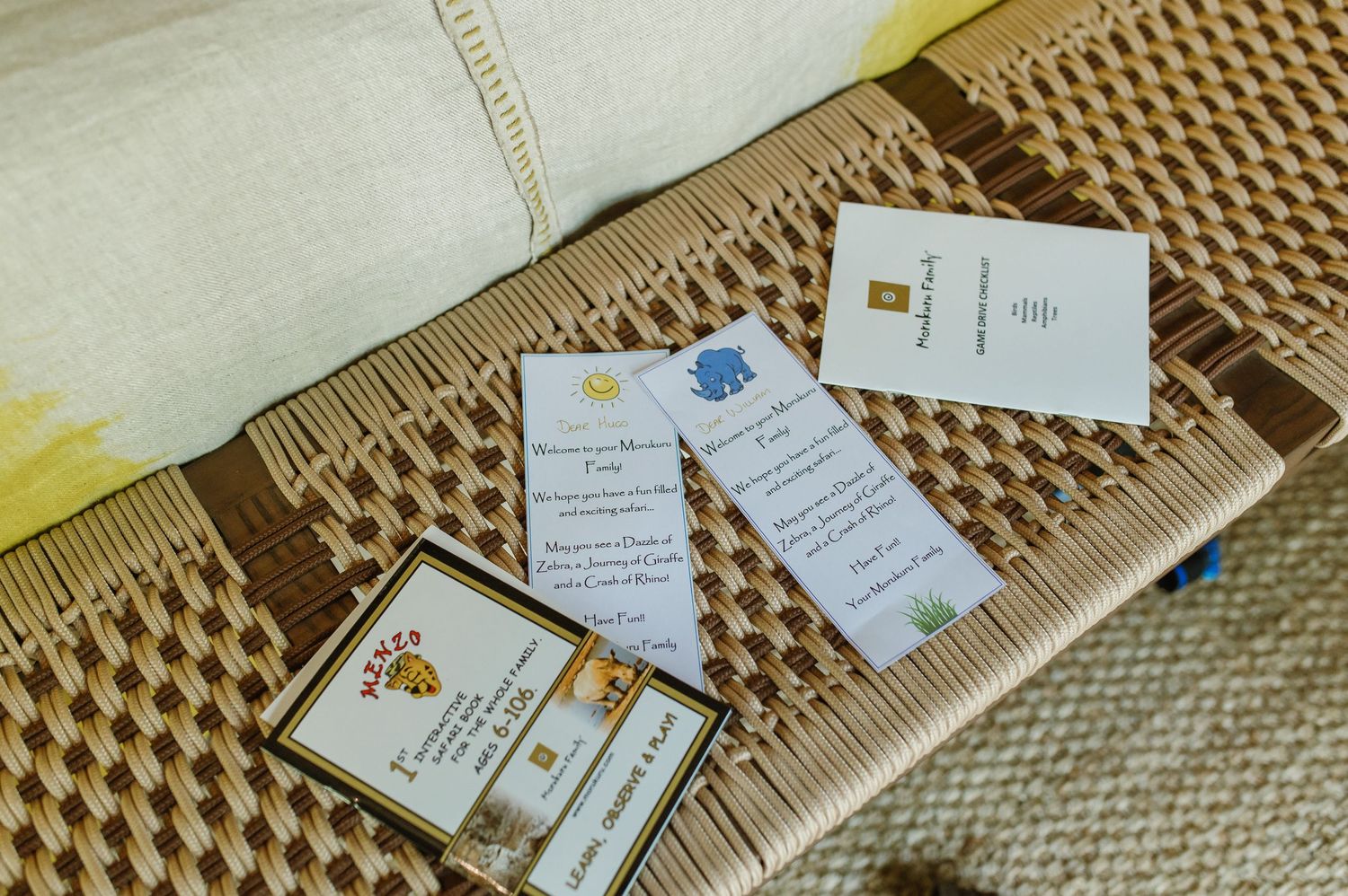 Wedding stationery and invitation suite laid out on a woven basket surface with cards and details.