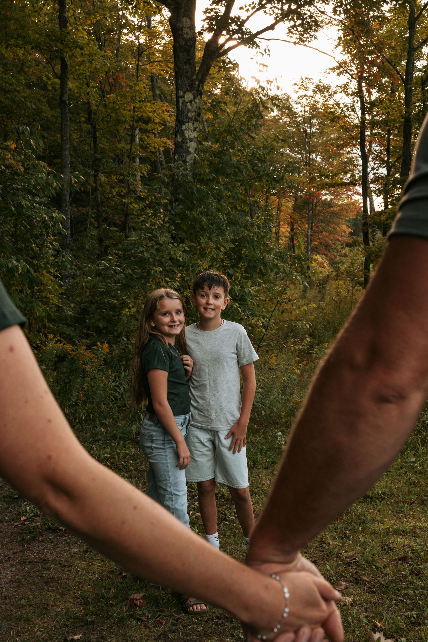 Creative photo series showing people walking through woods with hands reaching into frame.