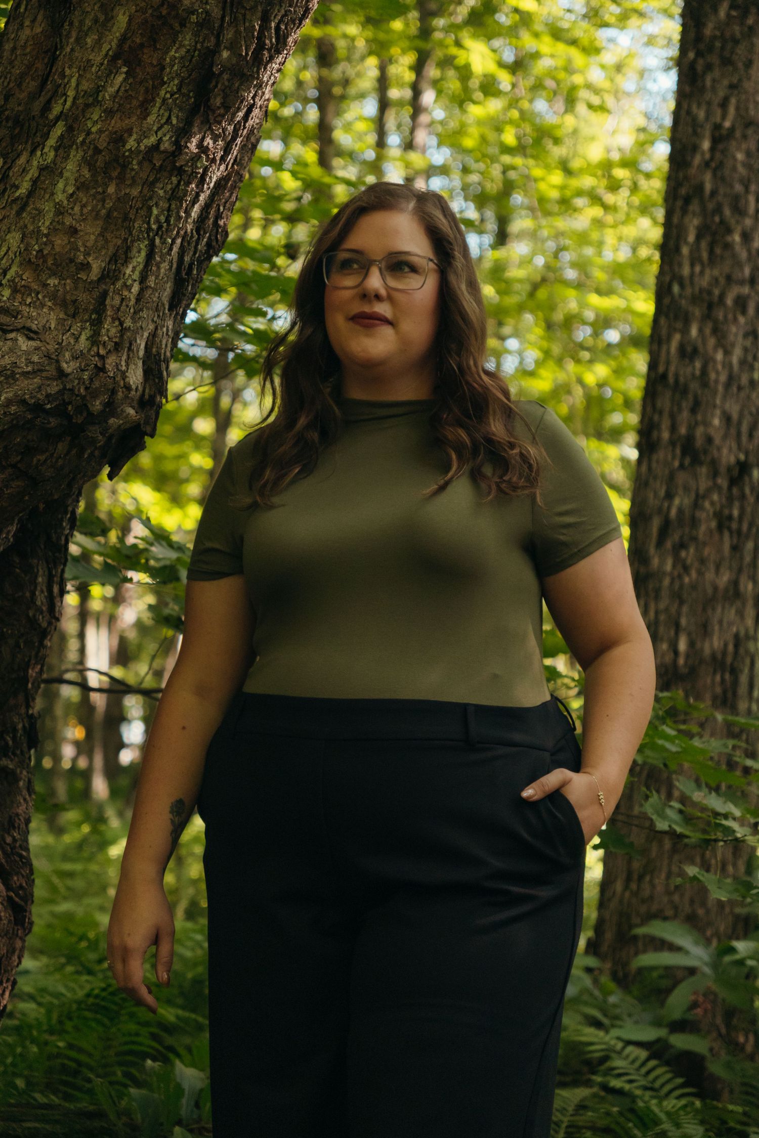 Outdoor portrait session in a wooded area with natural lighting.