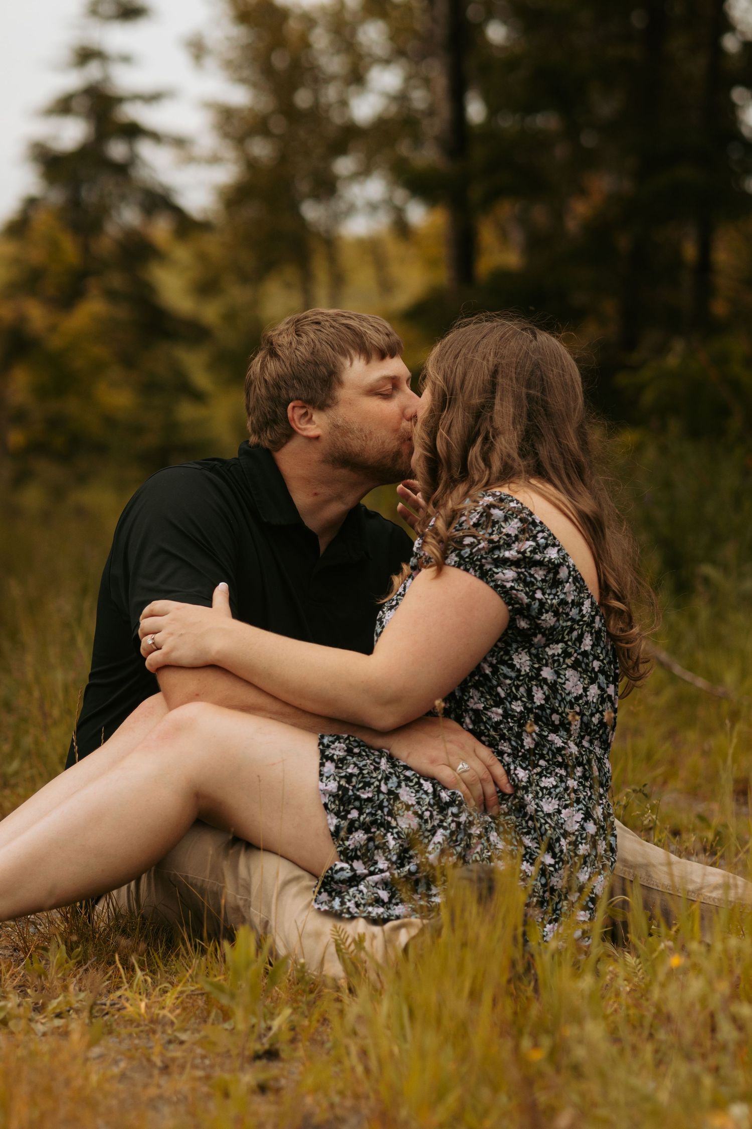 Intimate couple's portrait session in tall grass during golden hour.