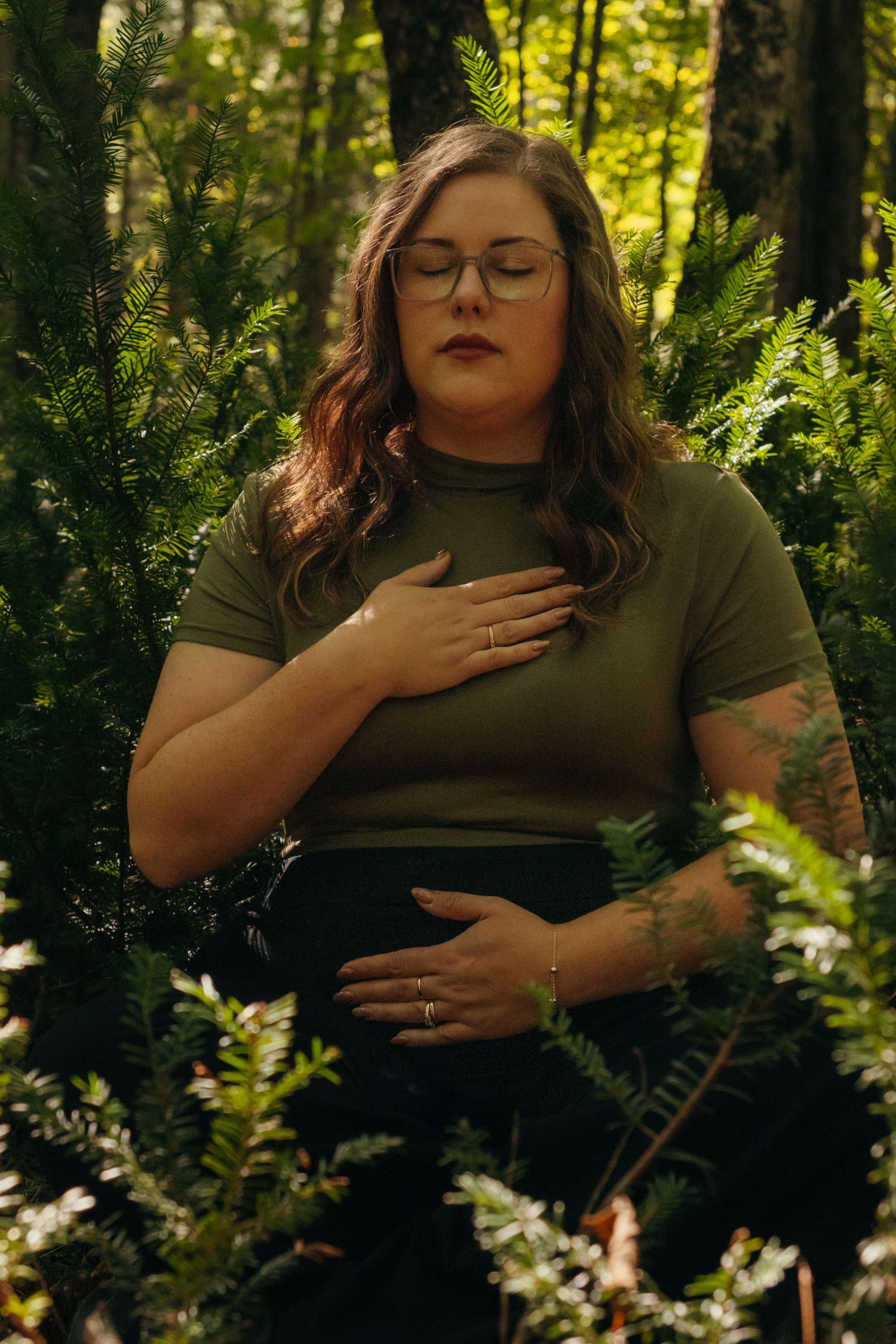 Forest photoshoot featuring a green t-shirt against lush woodland backdrop.
