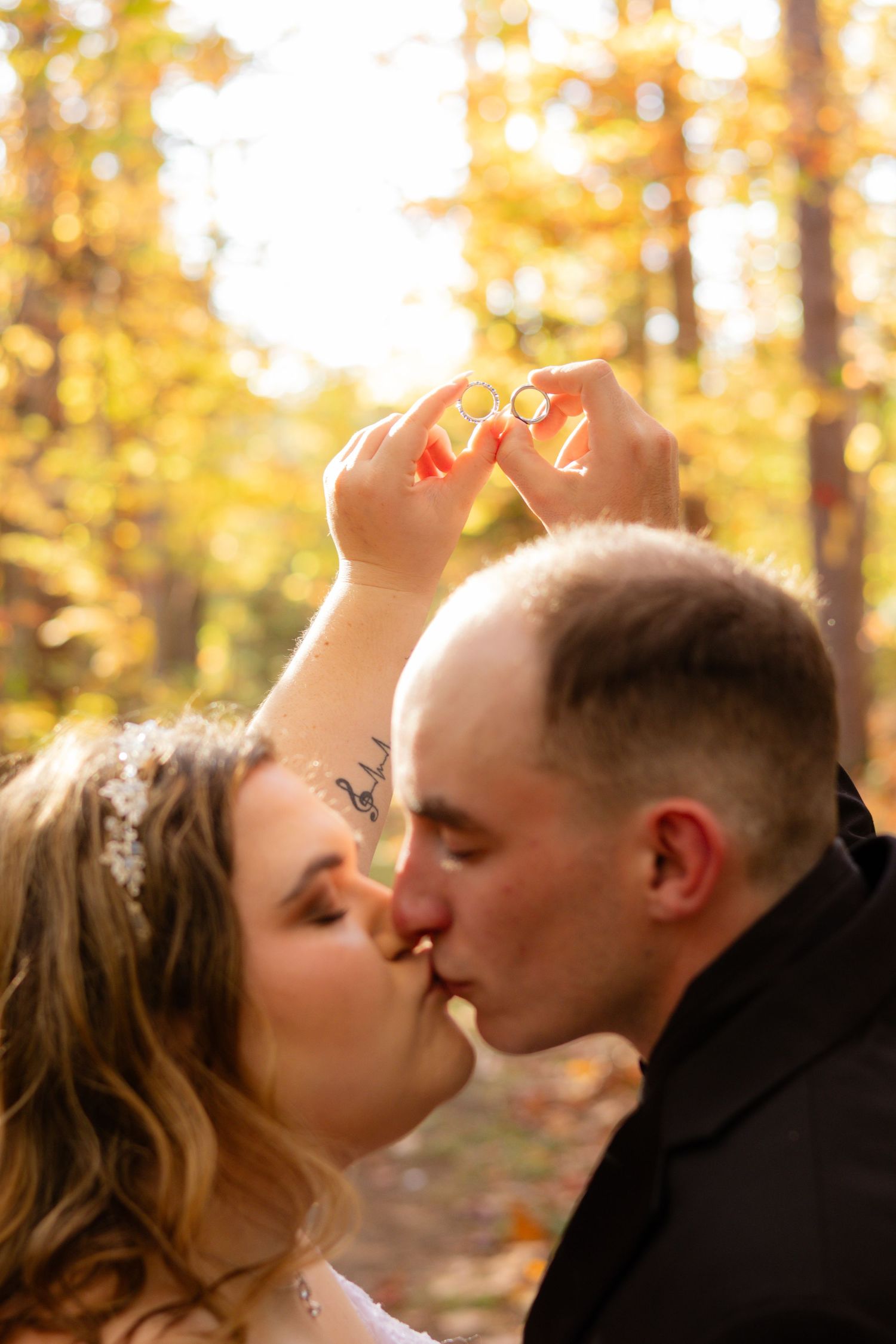 A romantic autumn wedding portrait capturing an intimate moment in golden sunlight.