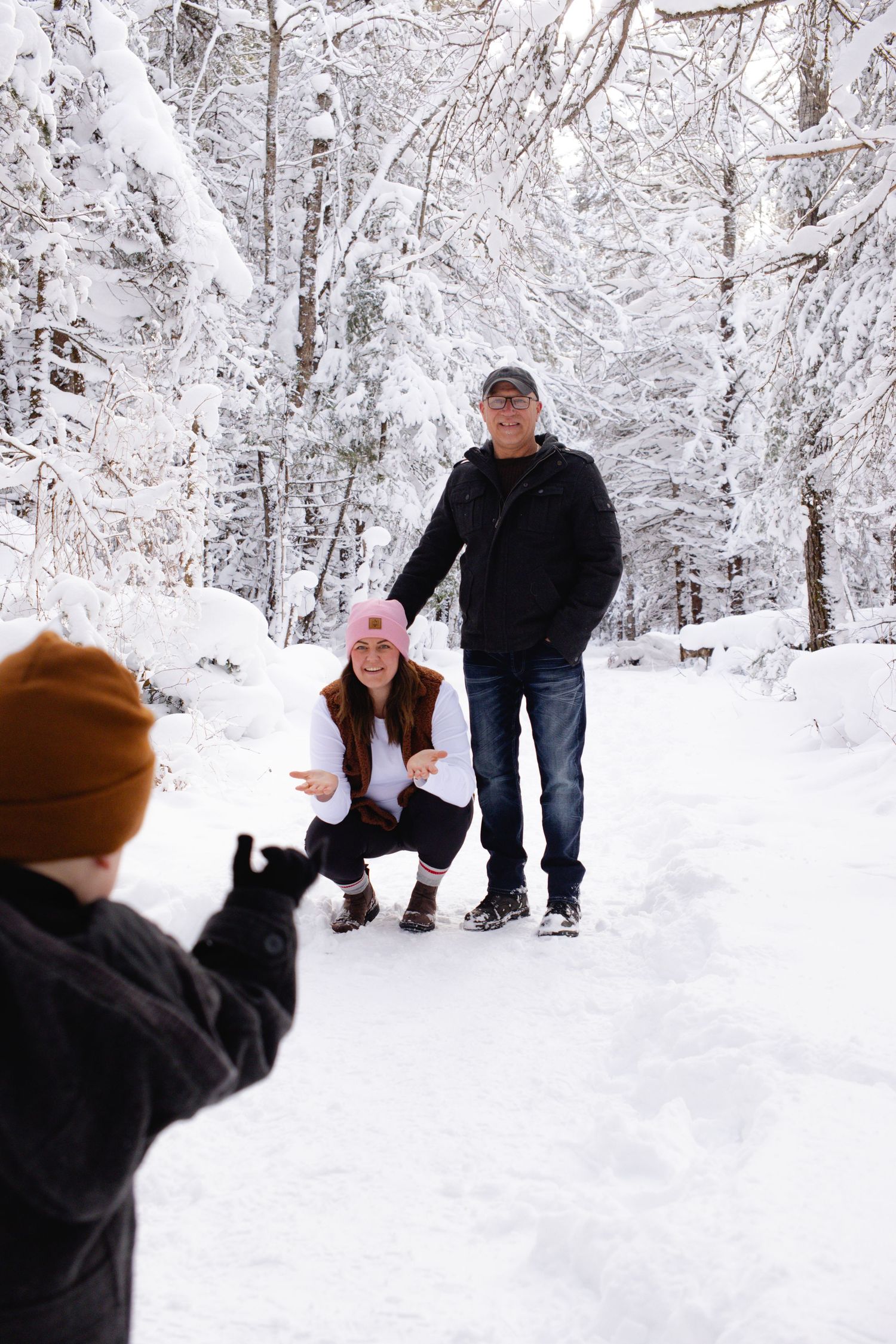 A winter proposal scene captured in a snow-covered forest setting.