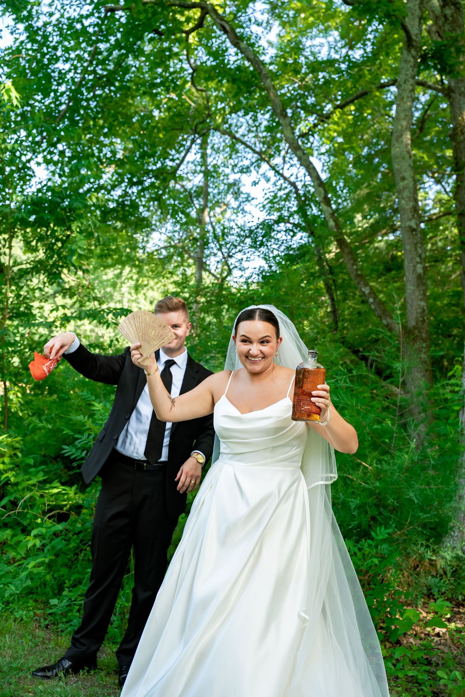 Virginia bride and groom celebrate after digging up the bottle of whiskey they buried at Avonlea Farms in the southern tradition