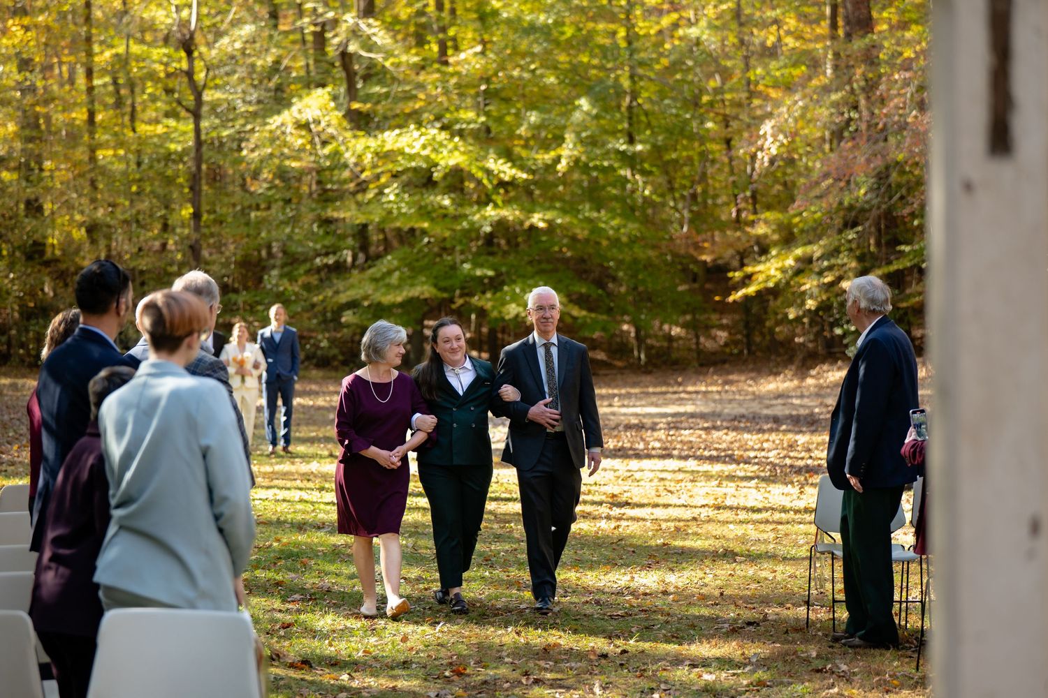 Brides are walked down the aisle by their parents in a beautiful Virginia fall wedding featuring autumn foliage