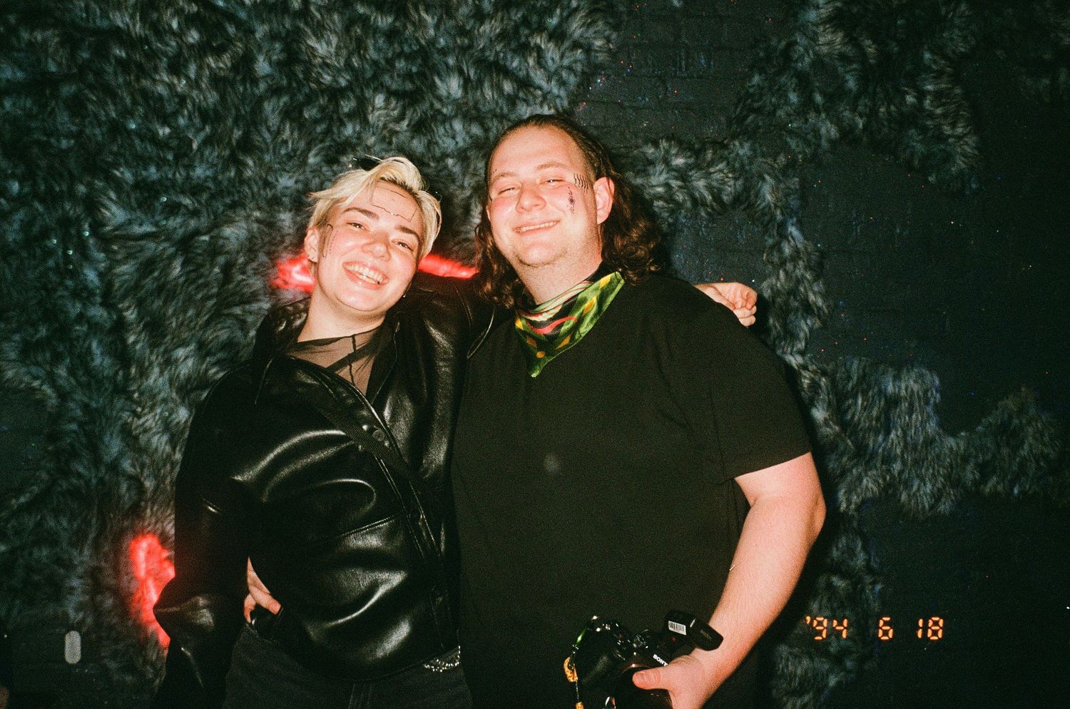 Maine-based queer wedding photographer Daniel Bowler posed in party photo with nonbinary partner at LBGT event