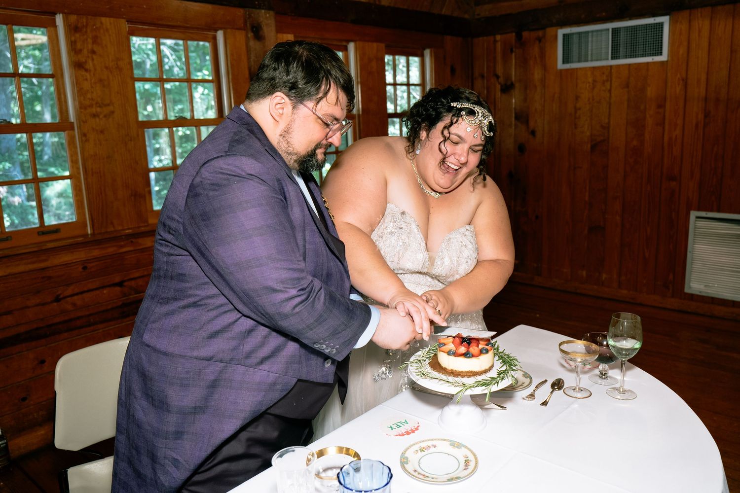 Richmond Virginia couple cut their wedding slicing cake during their reception at the banquet hall of Pocahontas State Park