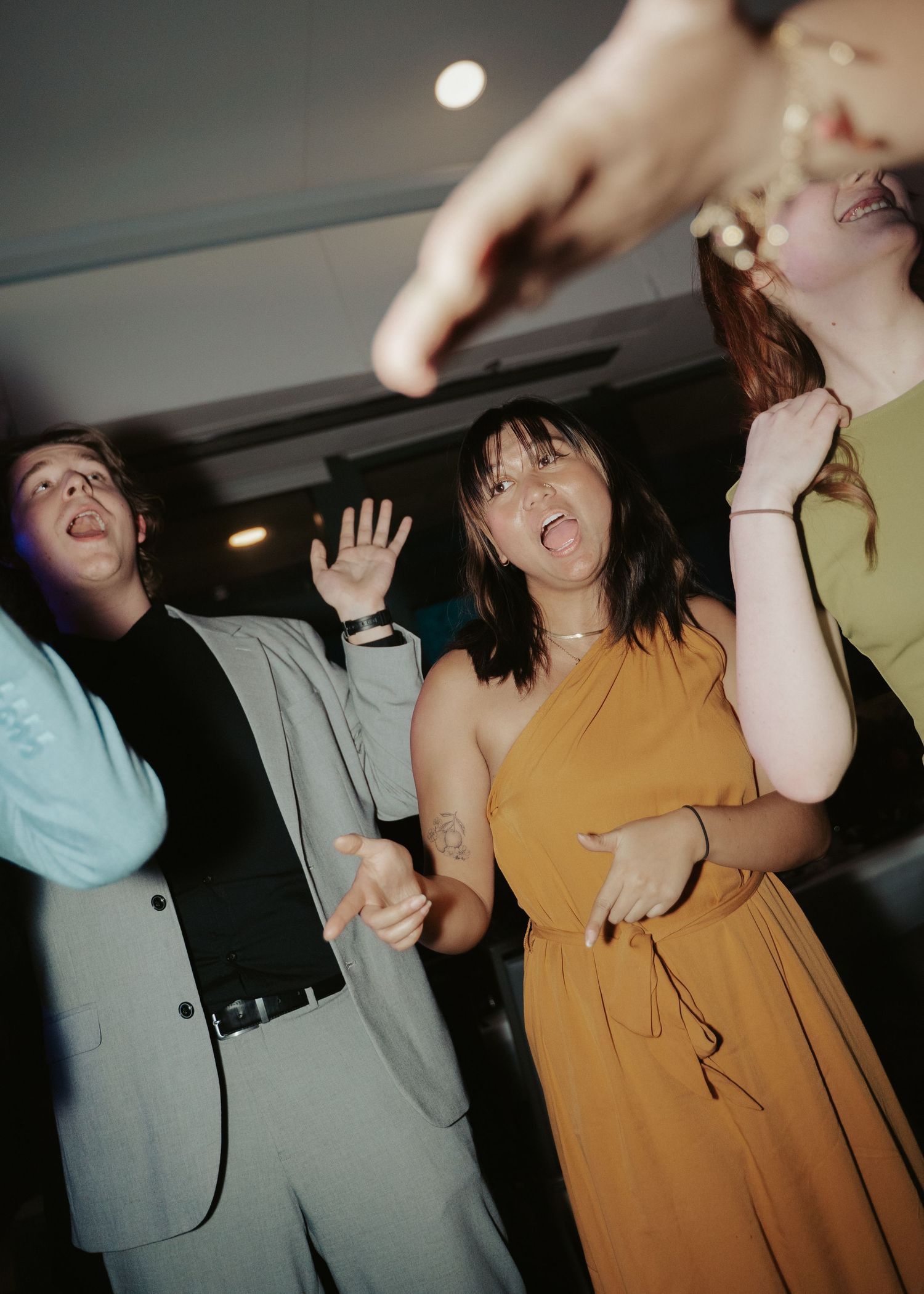 Two wedding guests make faces on the dancefloor of a gay wedding reception in Maryland