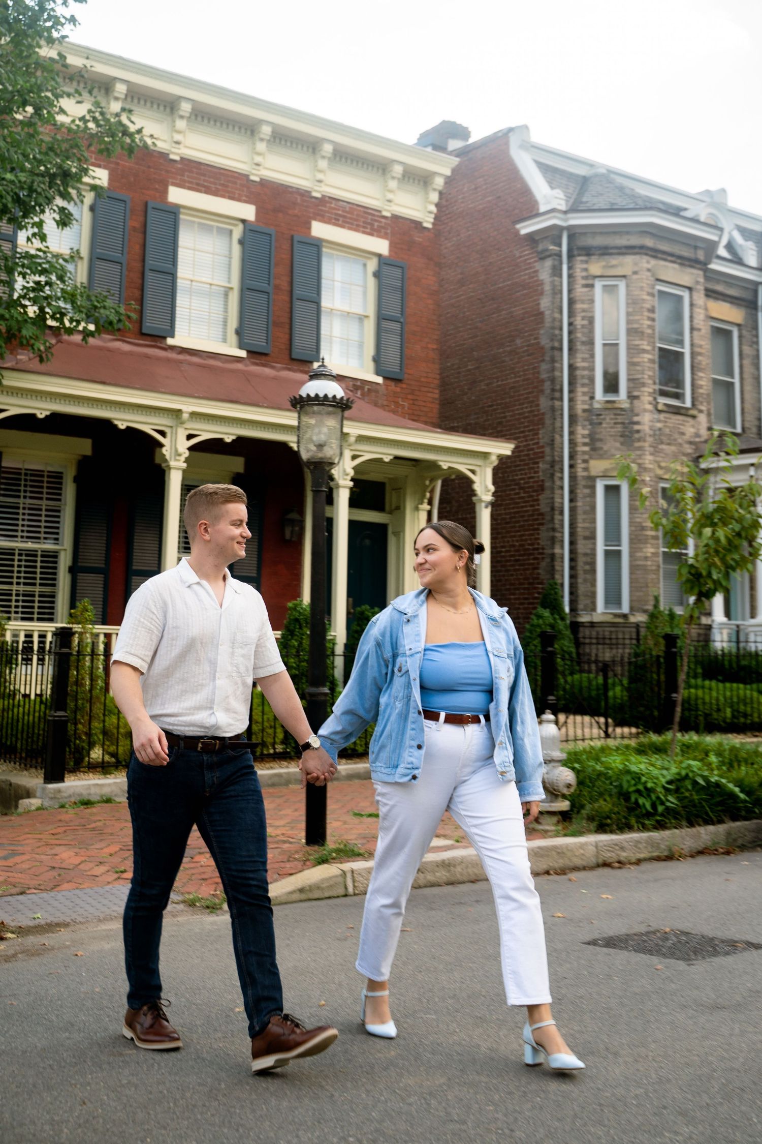 Couple celebrates their engagement walking through local neighborhood in Richmond VA for casual, cool, classic street-style photo session