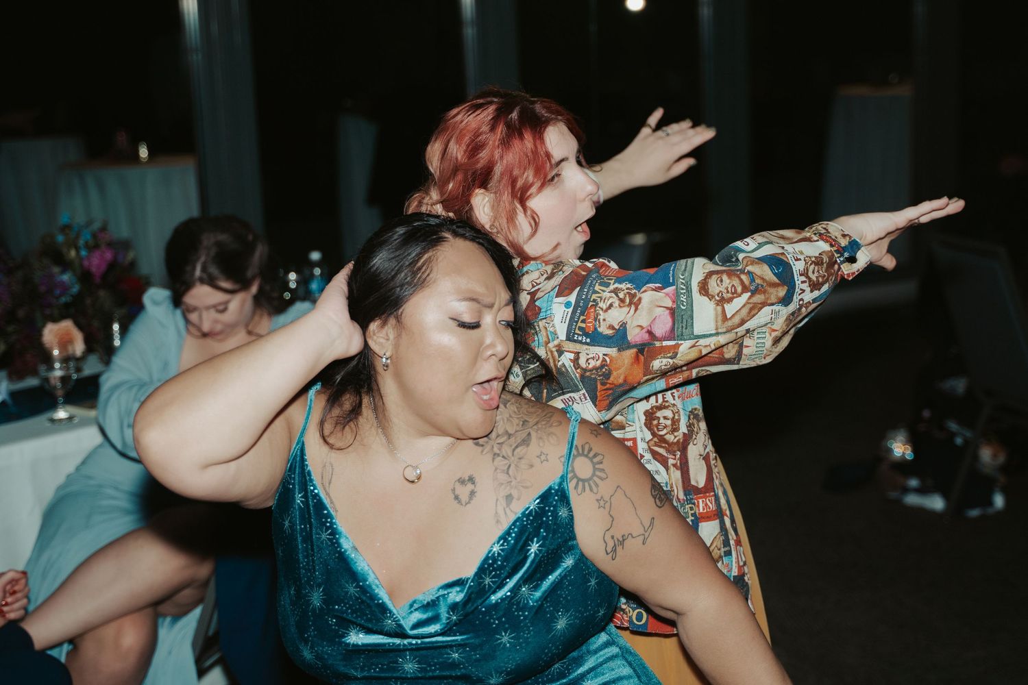 Two wedding guests dance back-to-back during the reception of a queer wedding in MAryland