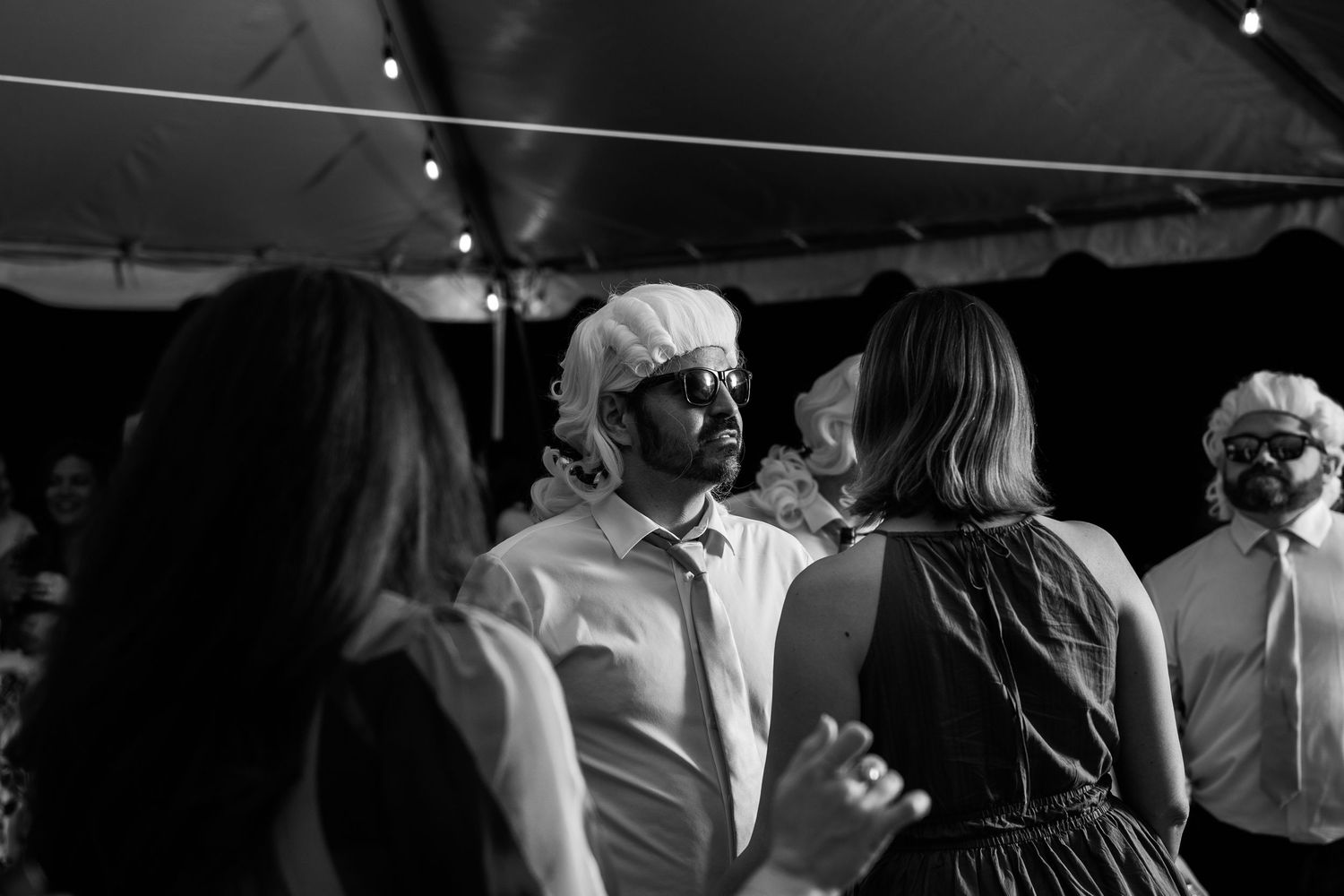Groomsmen in sunglasses and colonial wig grooves on the dancefloor in Church Hill, Richmond Virginia