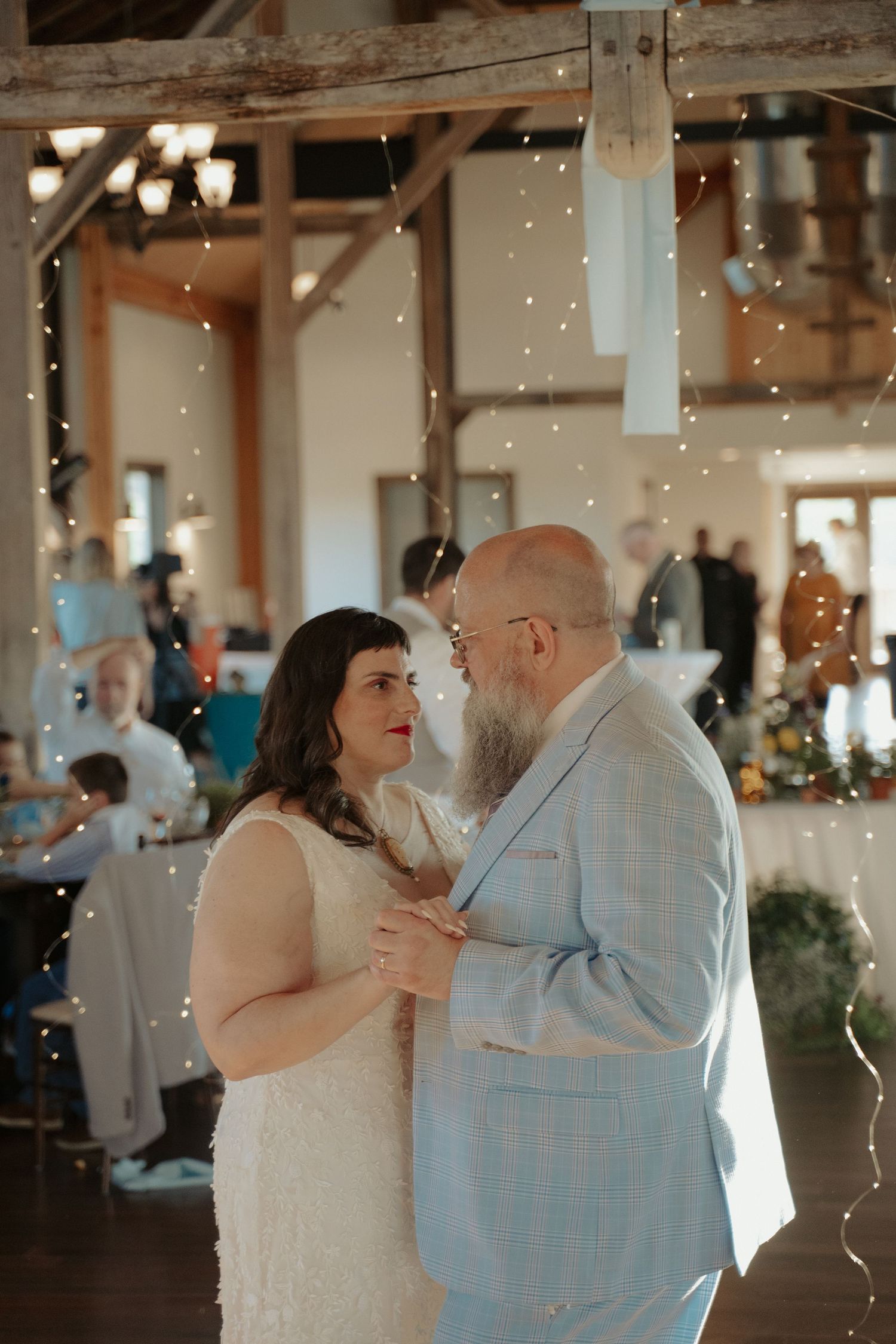Blue ridge mountains bride and groom in white dress and baby blue suit sway to their first dance song