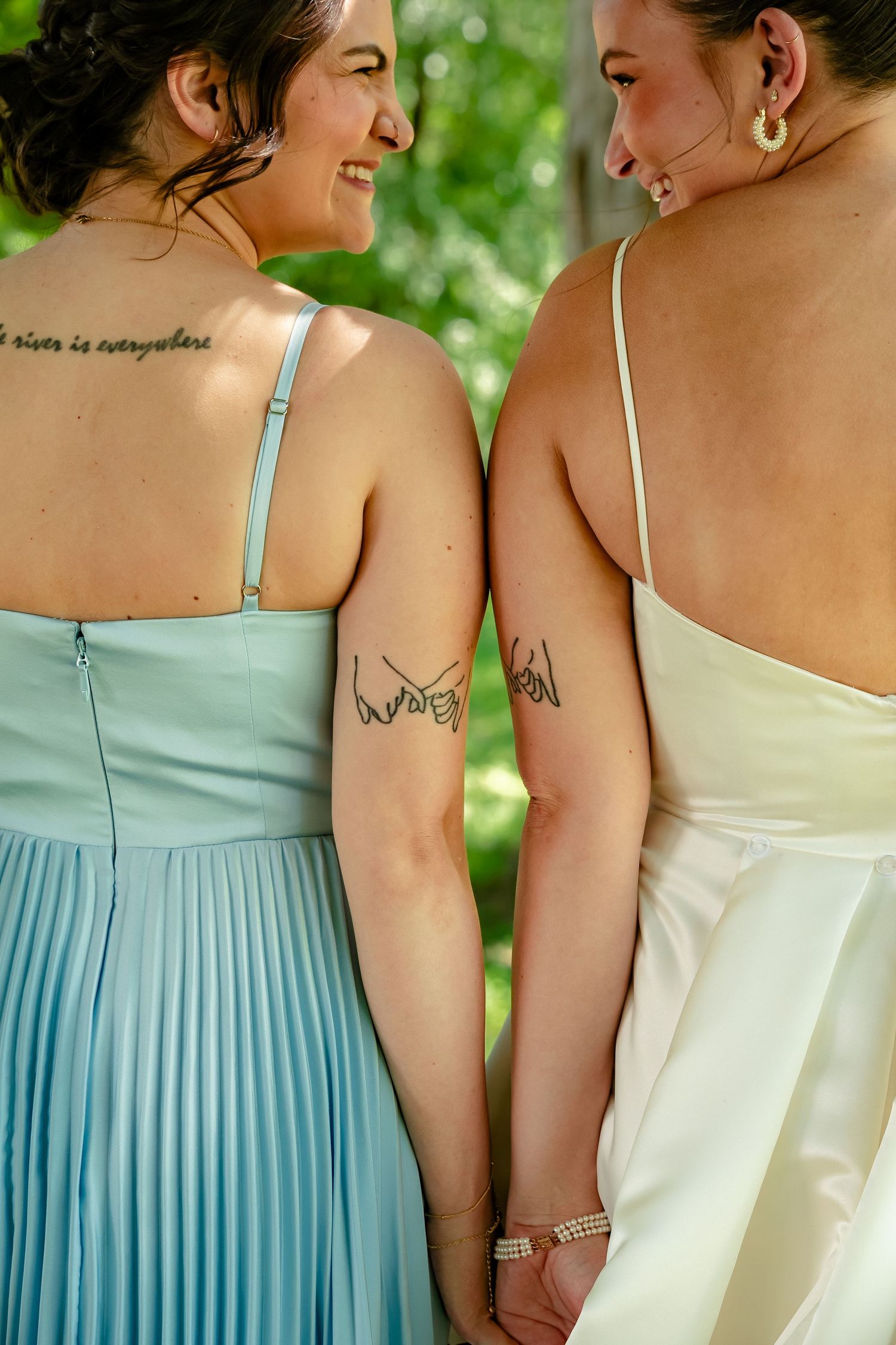 Bride and her sister hold hands and show off their pinky promise matching tattoos before her wedding day at Avonlea Farms outside Richmond