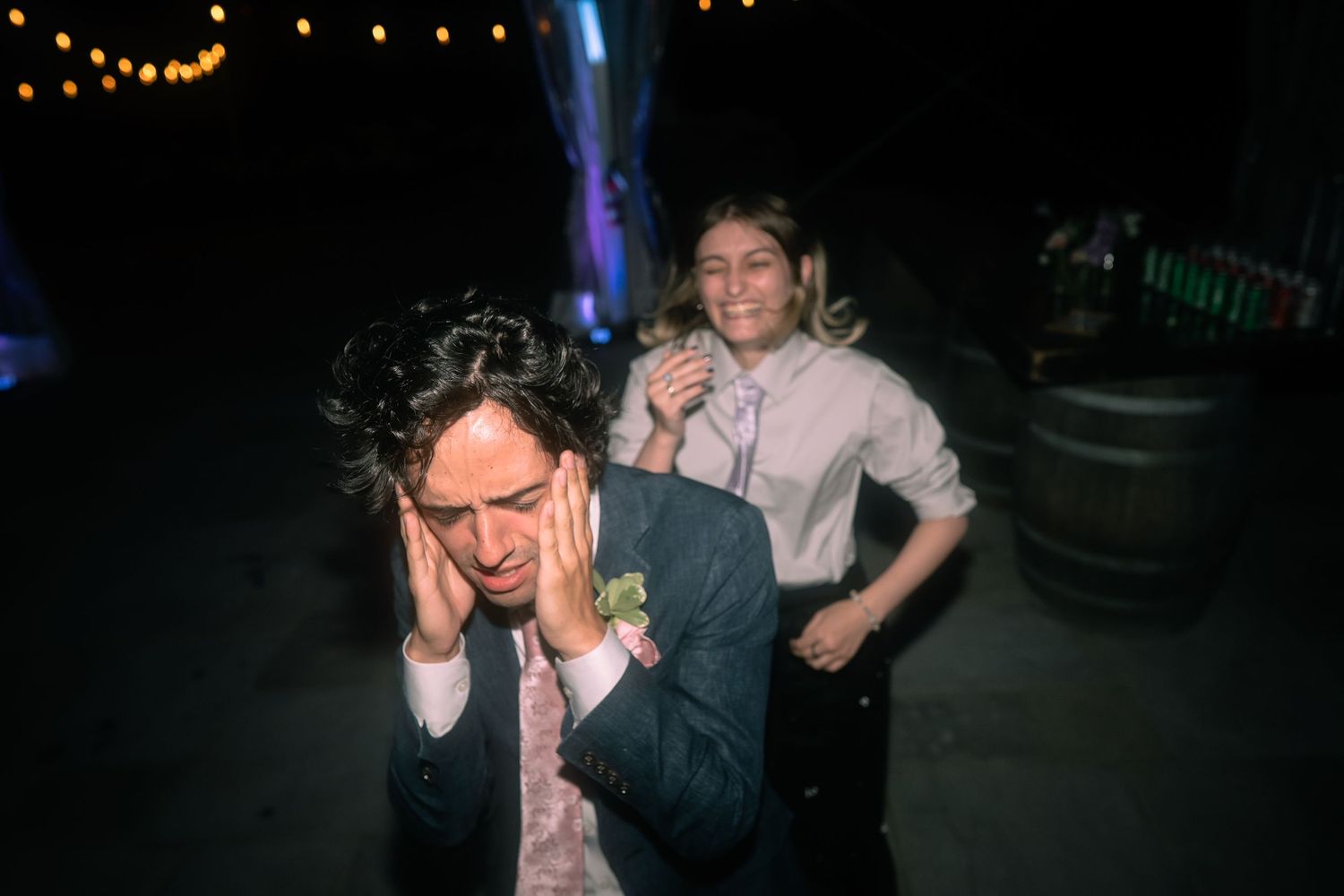 Two wedding party members dance in a silly way during an LGBTQ wedding at The Market at Grelen