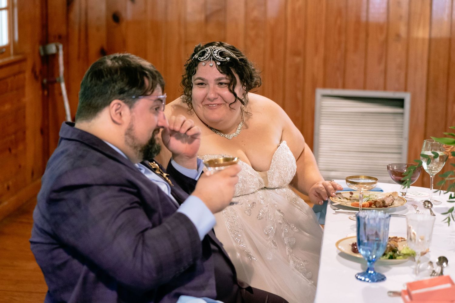Virginia bride comforts her groom as he wipes away tears caused by his best man's toast at Pocahontas State Park
