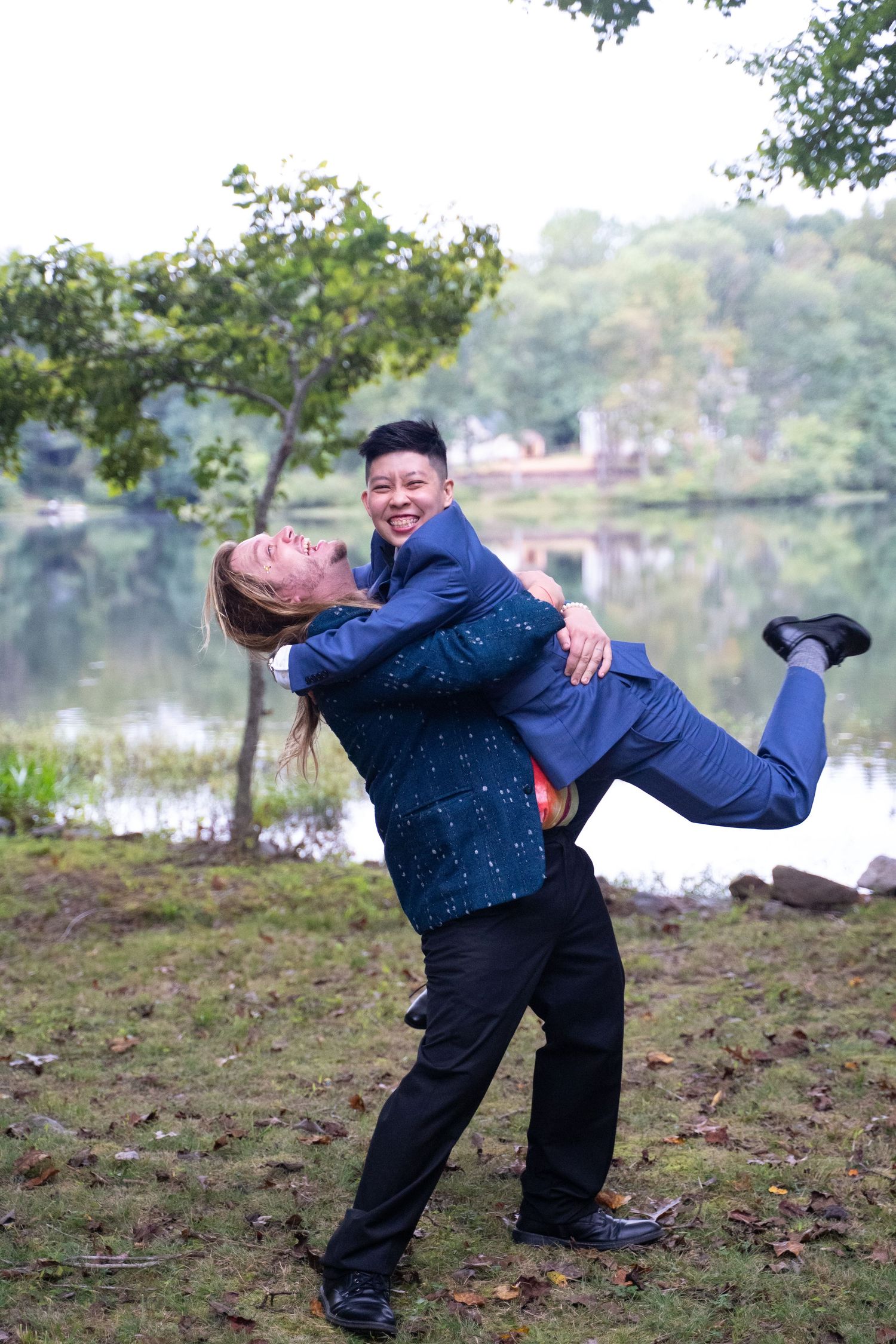 A groom is swung up into the air by a friend at his LGBTQ wedding in tidewater Virginia