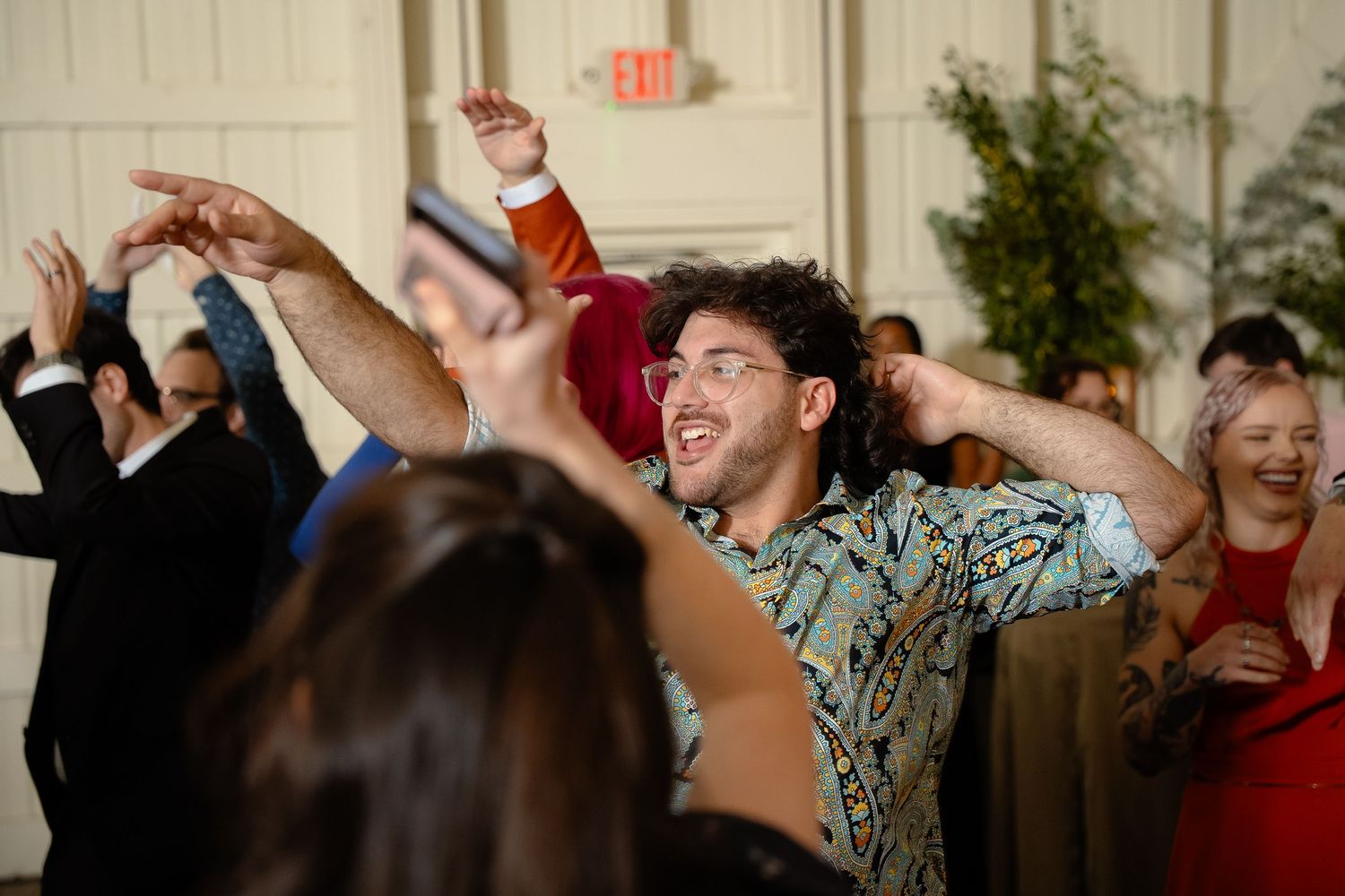 Wedding guest points on the dancefloor during a gay wedding in Charlottesville Virginia