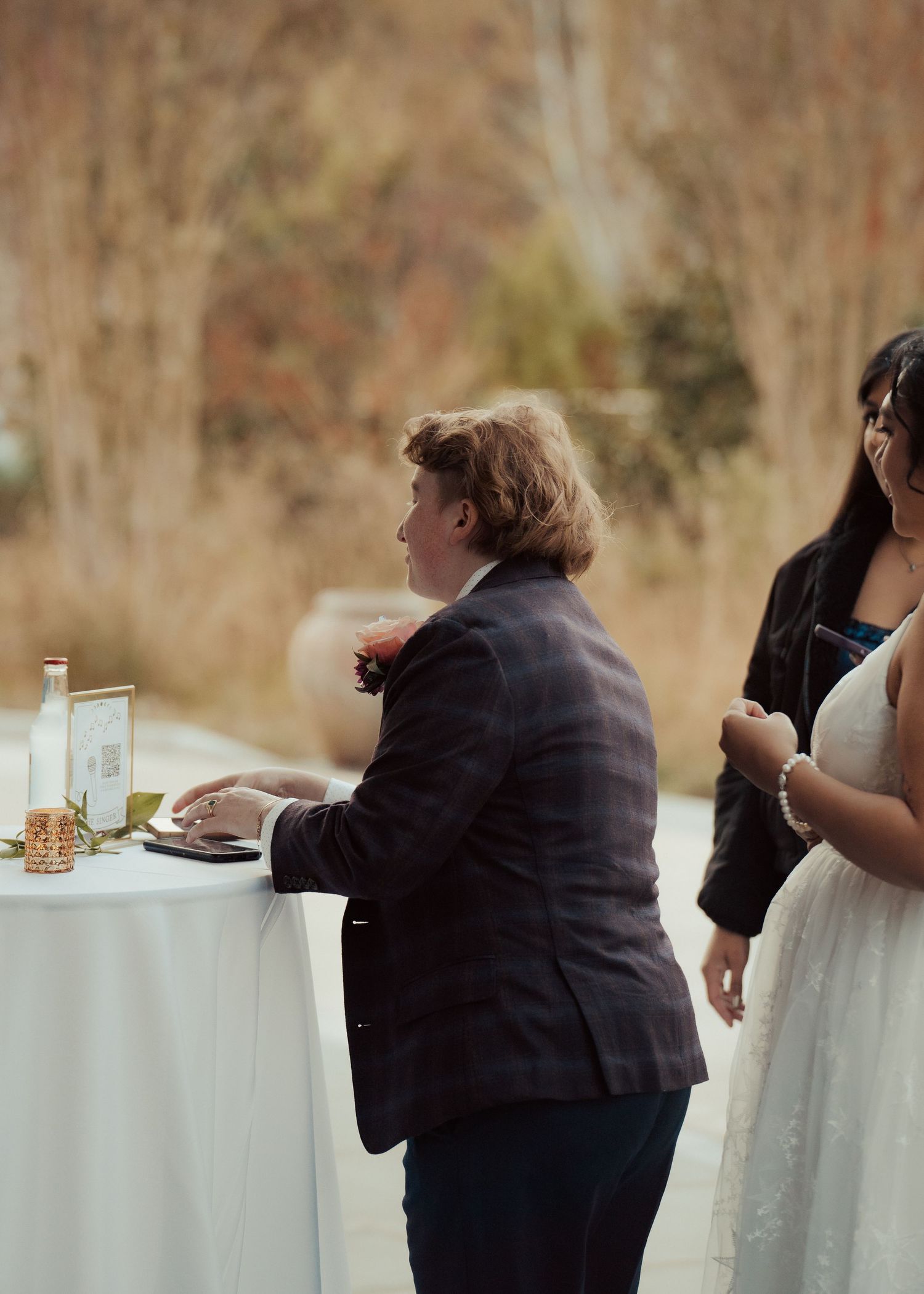 LGBTQ newlywed is pranked on their wedding day by a member of their party during cocktail hour in documentary style by Maine Photographer.