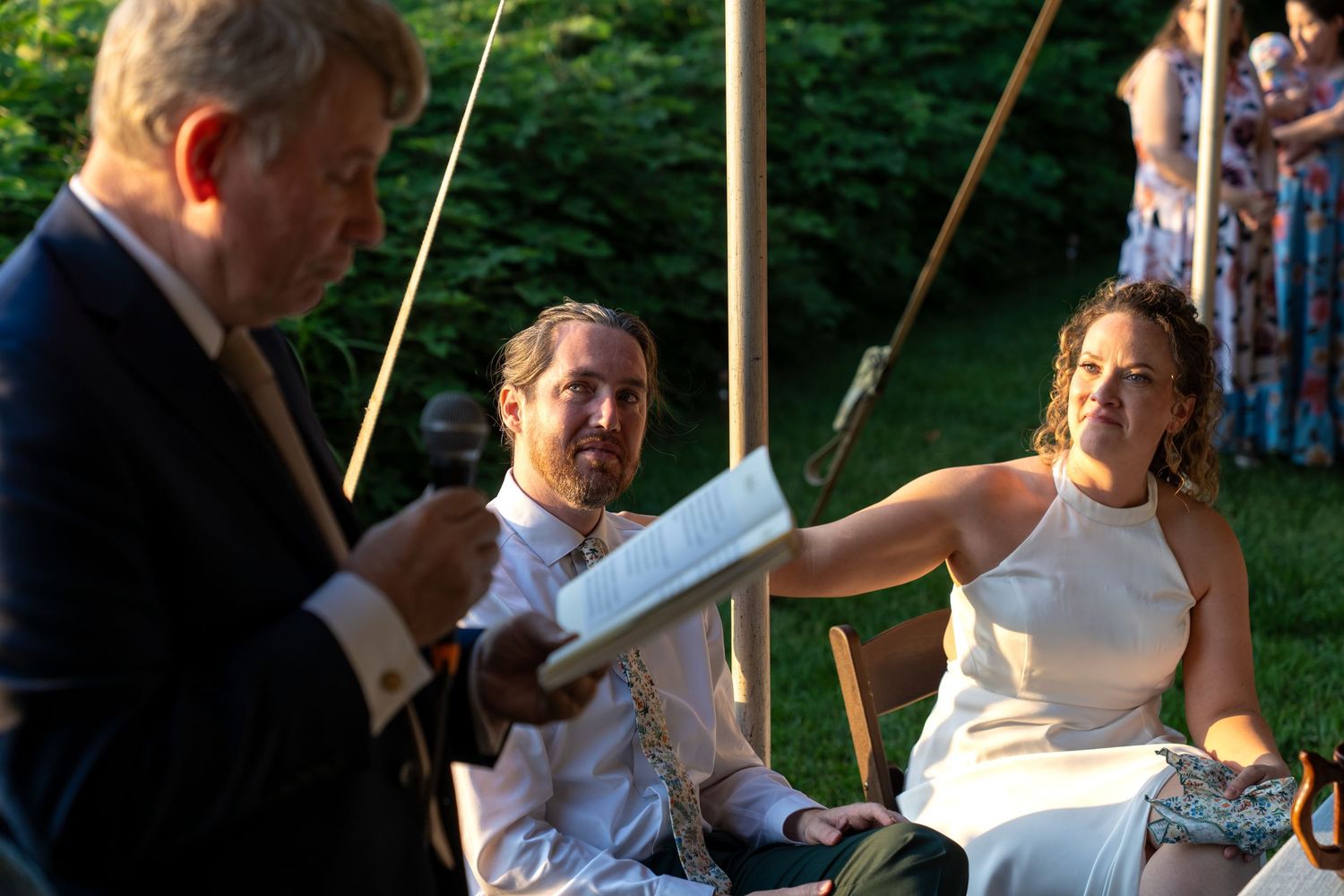 Groom looks warmly to his father in law while he toasts the couple during the reception at Church Hill in Richmond Virginia