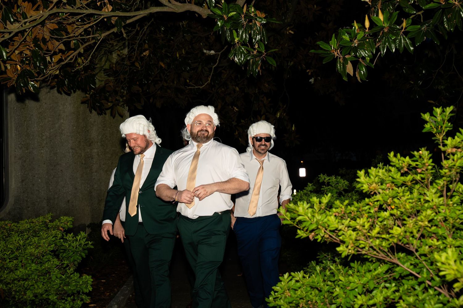 Three groomsmen in colonial wigs approach a wedding dancefloor in Church Hill, Richmond Virginia