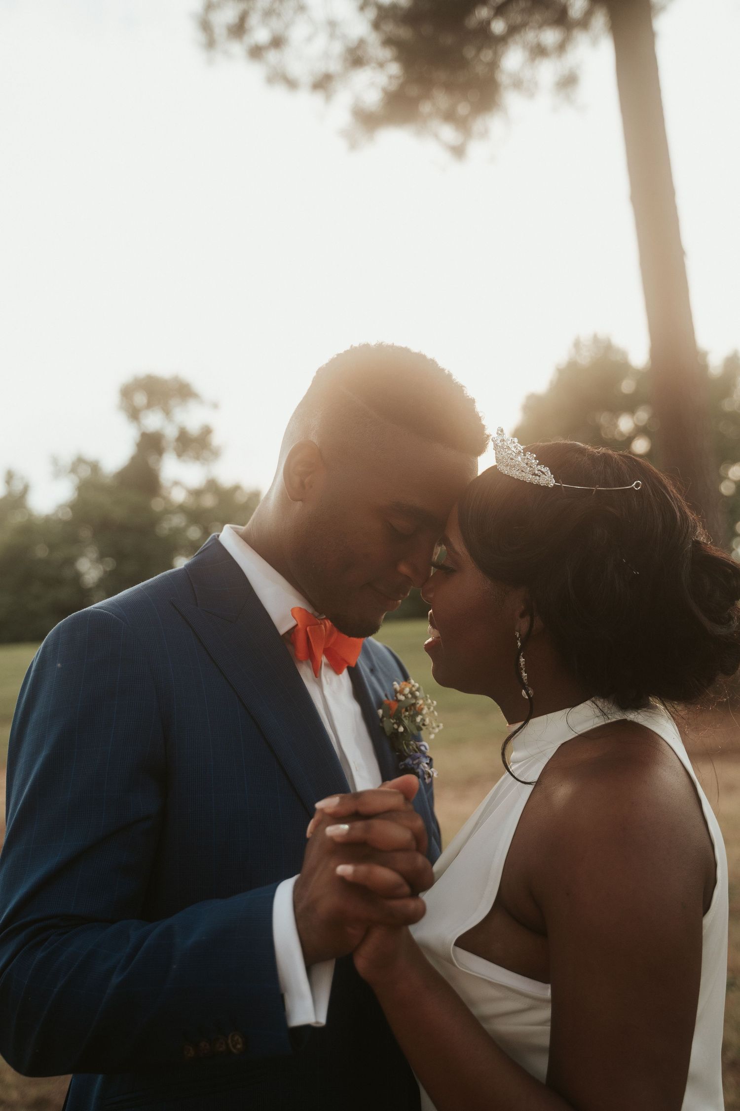 A tidewater couple breathe in close to each other under a dreamy and hazy sunset