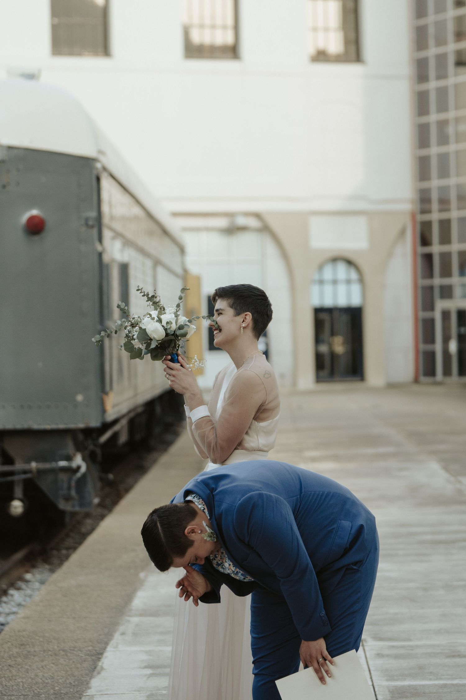 Two lgbtq brides take a deep breath after their modern wedding ceremony at Science Museum in Richmond Virginia