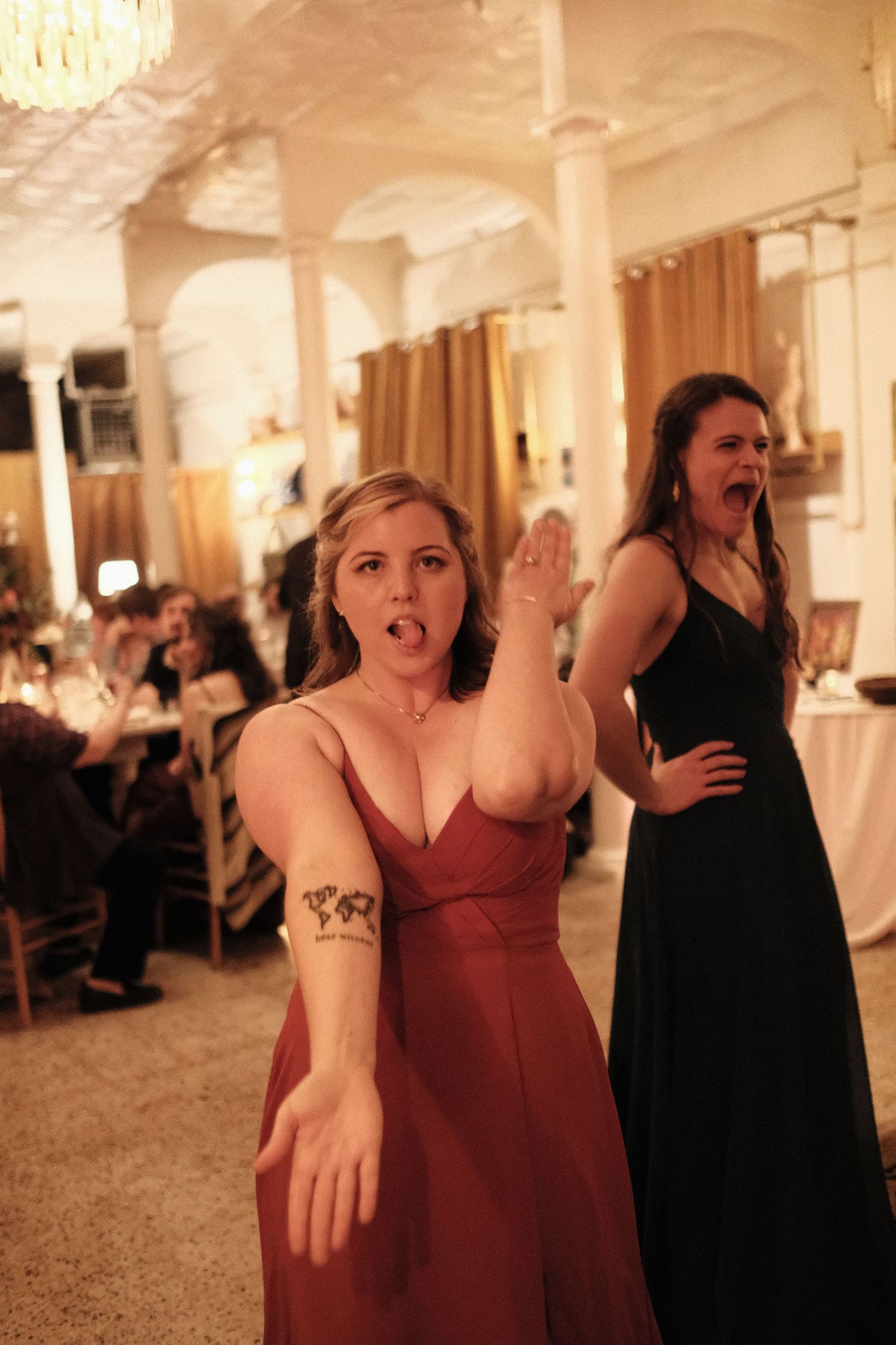 A bridesmaid vogues for the camera on the dancefloor of a wedding at Stella's restaurant in the Museum District of Richmond Virginia