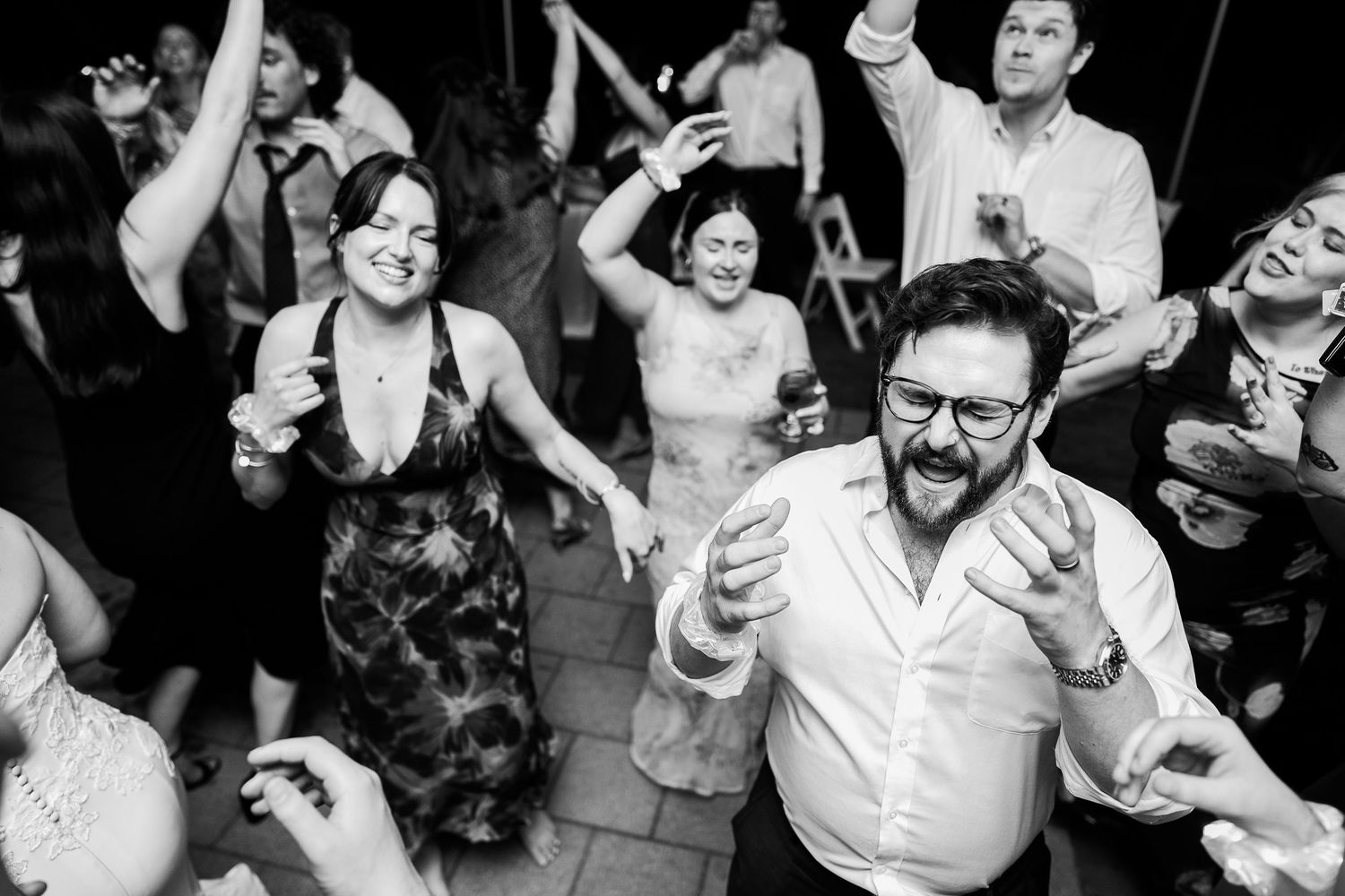 Wedding Guests sing loudly to the music during a reception in Richmond Virginia at the Lewis Ginter Botanical Gardens
