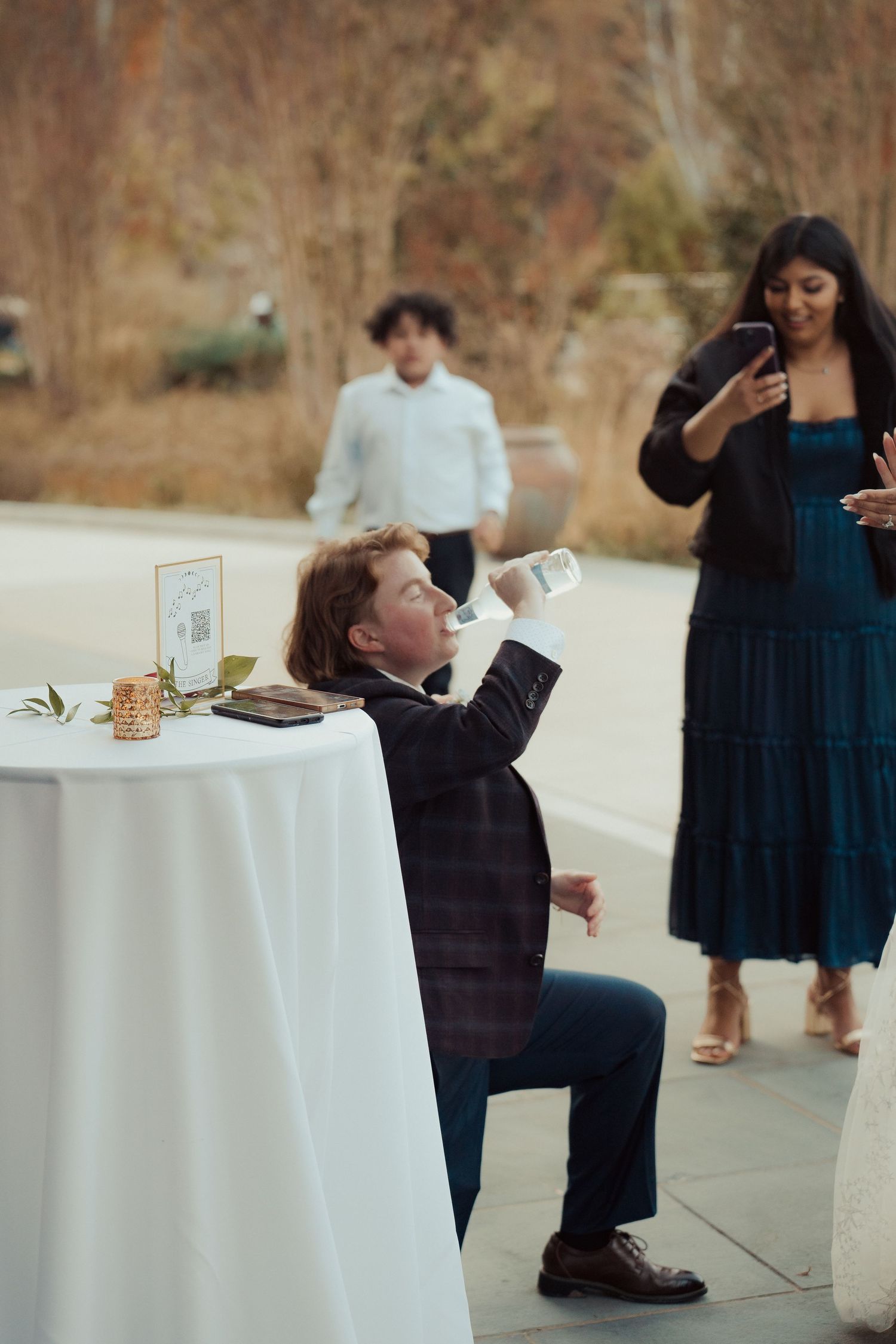 LGBTQ newlywed is pranked on their wedding day by a member of their party during cocktail hour in documentary style by Maine Photographer.
