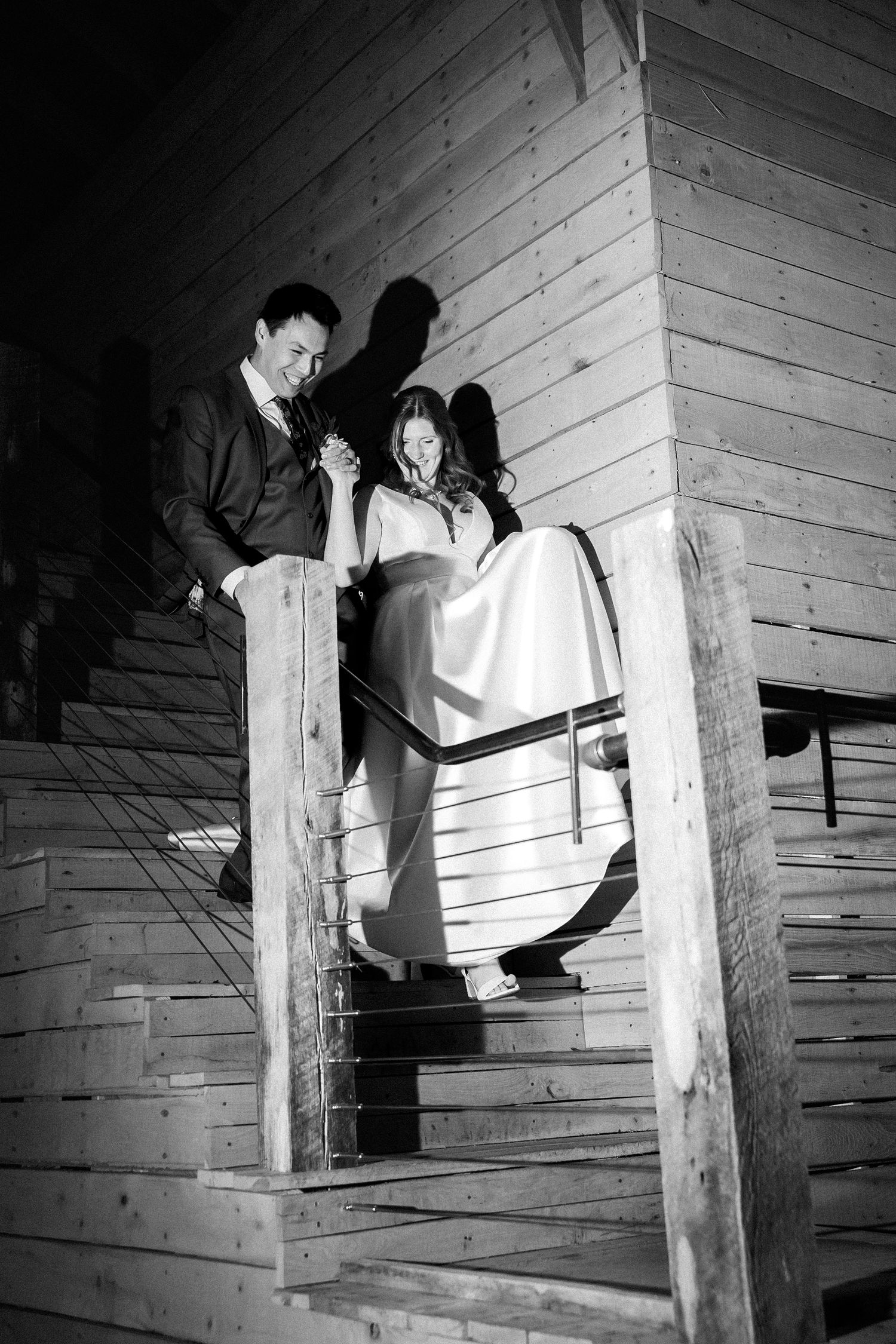 Blue ridge mountains couple descend the stairs of their venue to the dancefloor